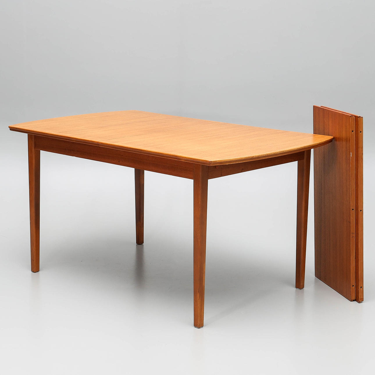 A three-piece teak veneer dining table, 1950s/60s.
