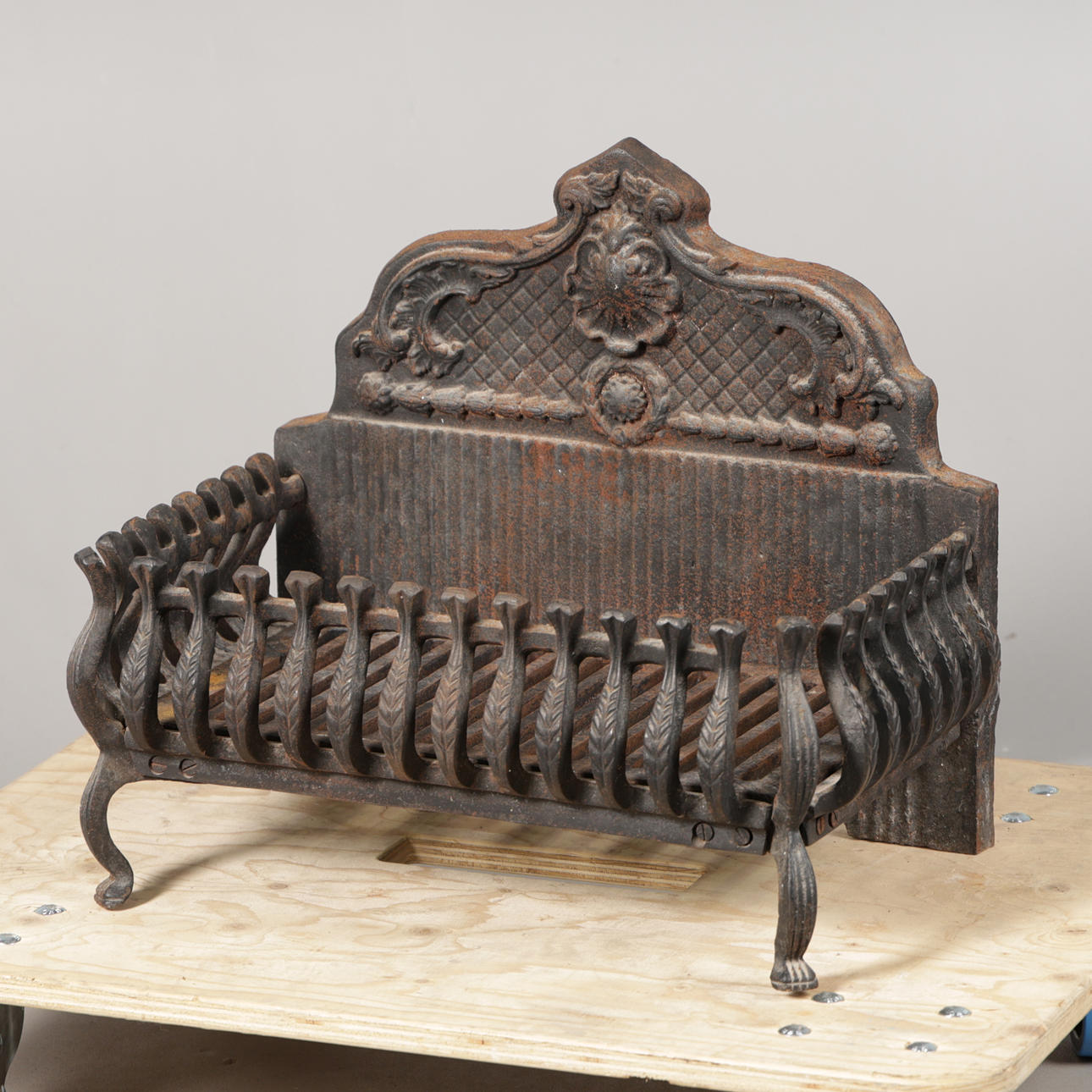 A WROUGHT-IRON FIRE BASKET.