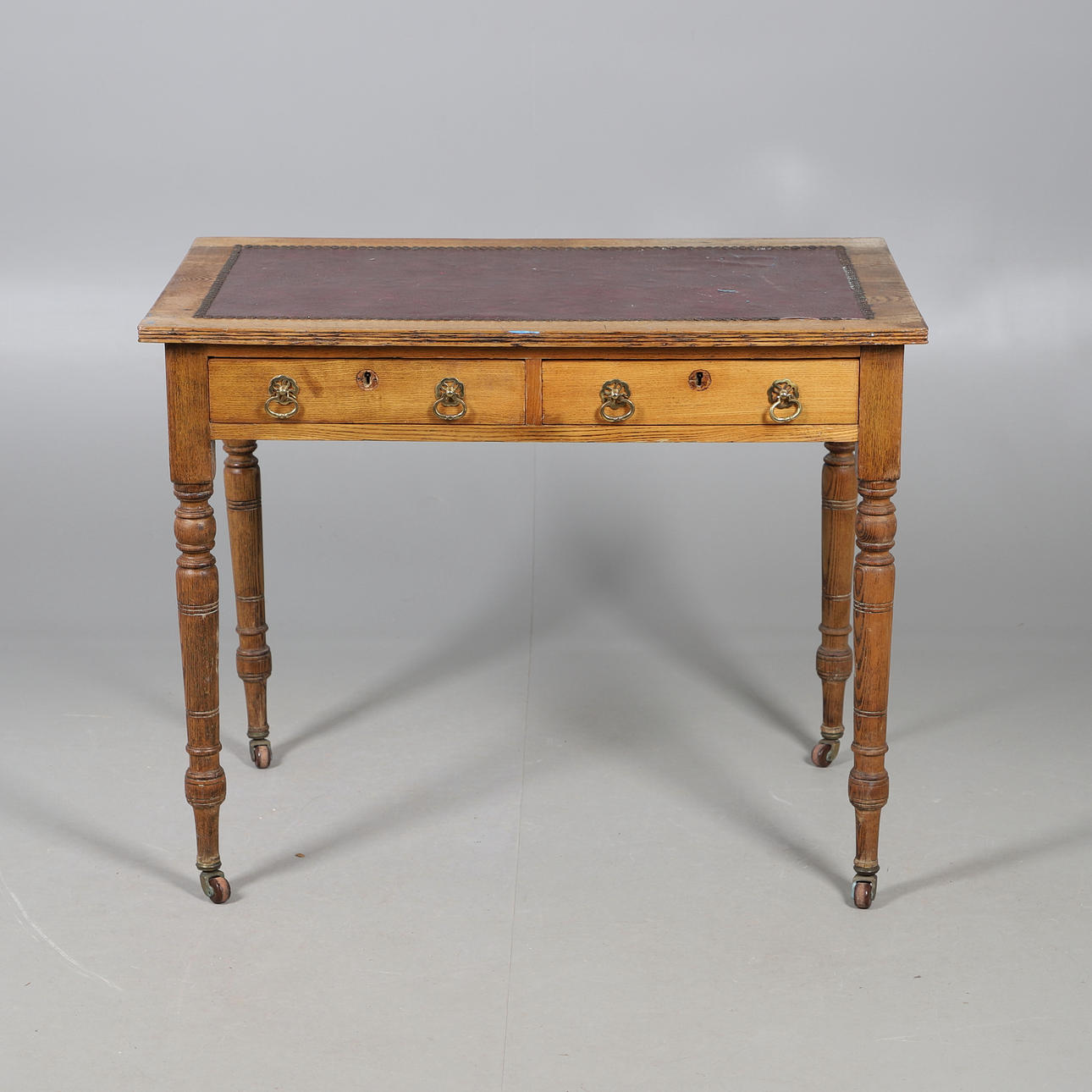 A VICTORIAN OAK WRITING TABLE, CIRCA 1880.