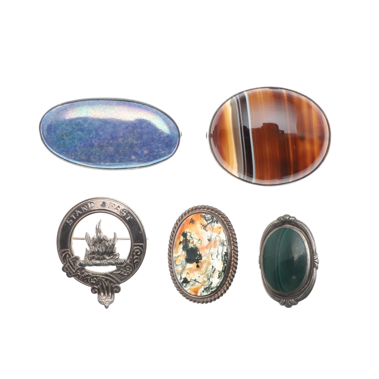 FIVE SILVER MOUNTED BROOCHES.