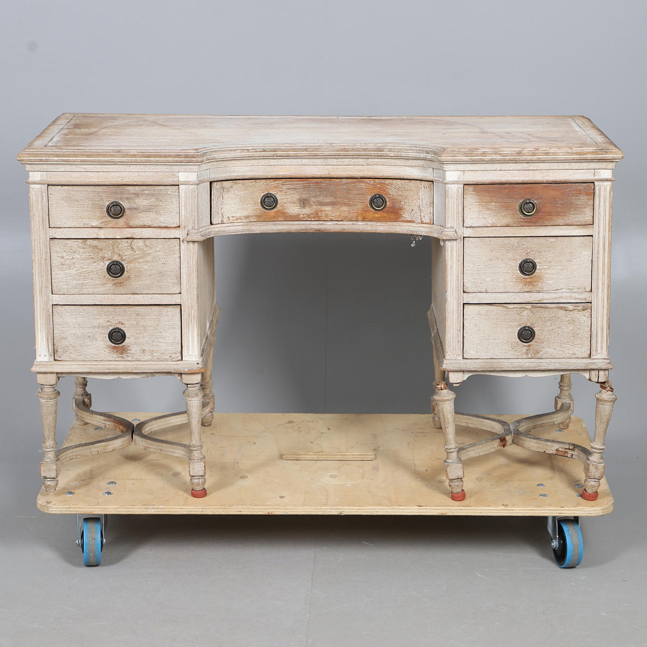 A LIMED WOOD PEDESTAL DRESSING TABLE.