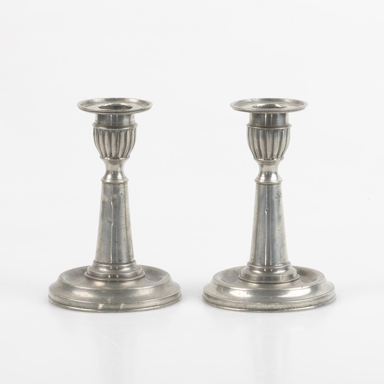 A pair of tin candlesticks, N.E. Justelius Eksjö.