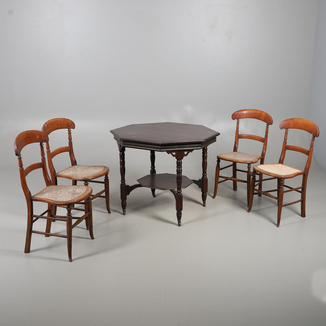 OCTAGONAL MAHOGANY BREAKFAST TABLE WITH FOUR CANE SEATED CHAIRS.