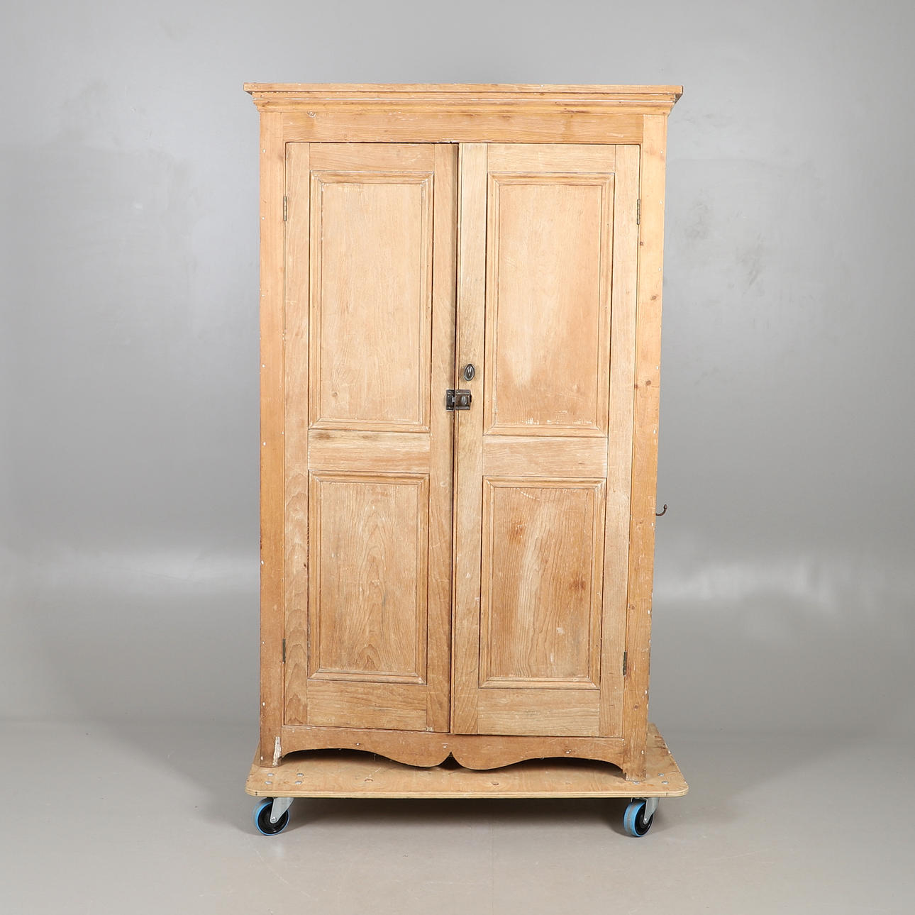 A STRIPPED PINE SCHOOL CUPBOARD.
