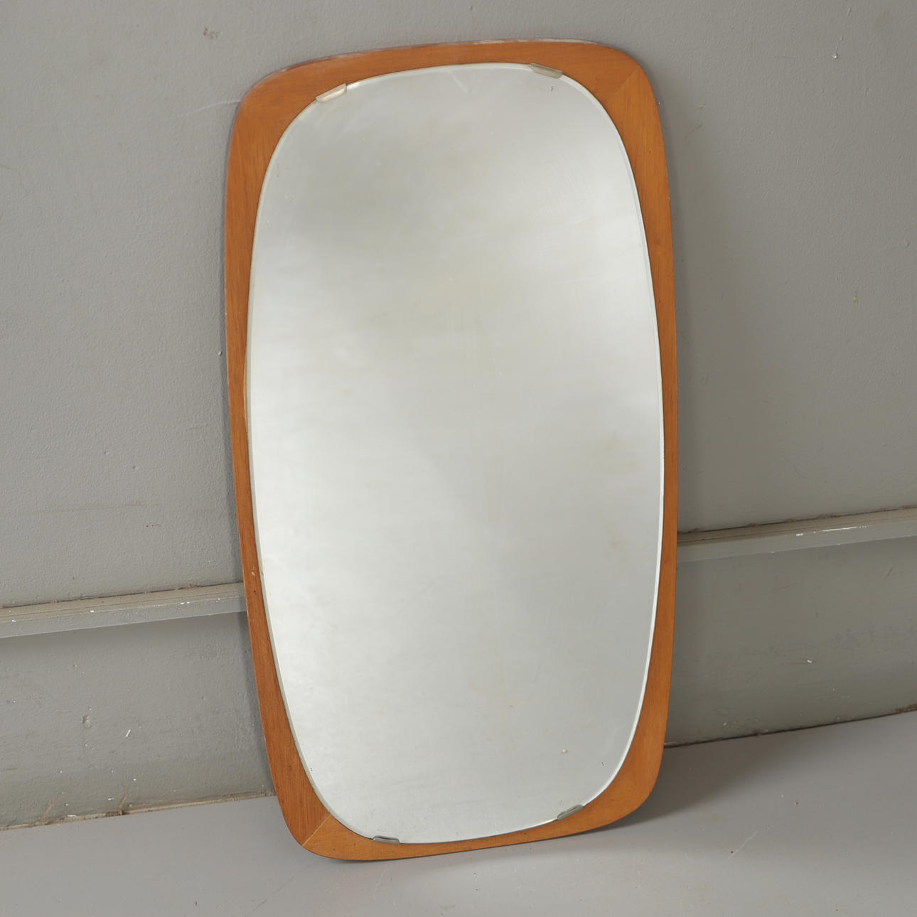 A mid 20th century teak mirror.