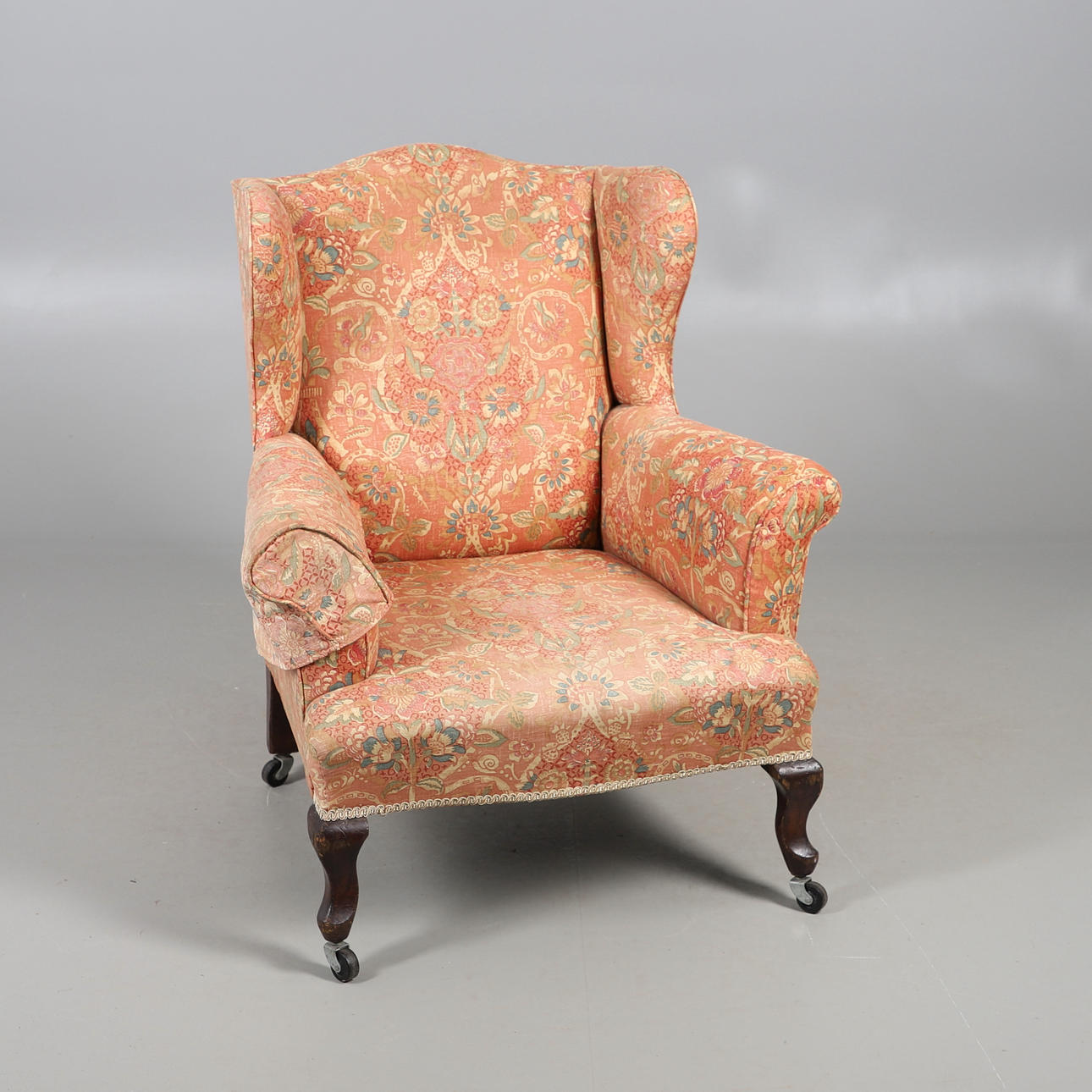 ANTIQUE WINGBACK UPHOLSTERED ARMCHAIR.