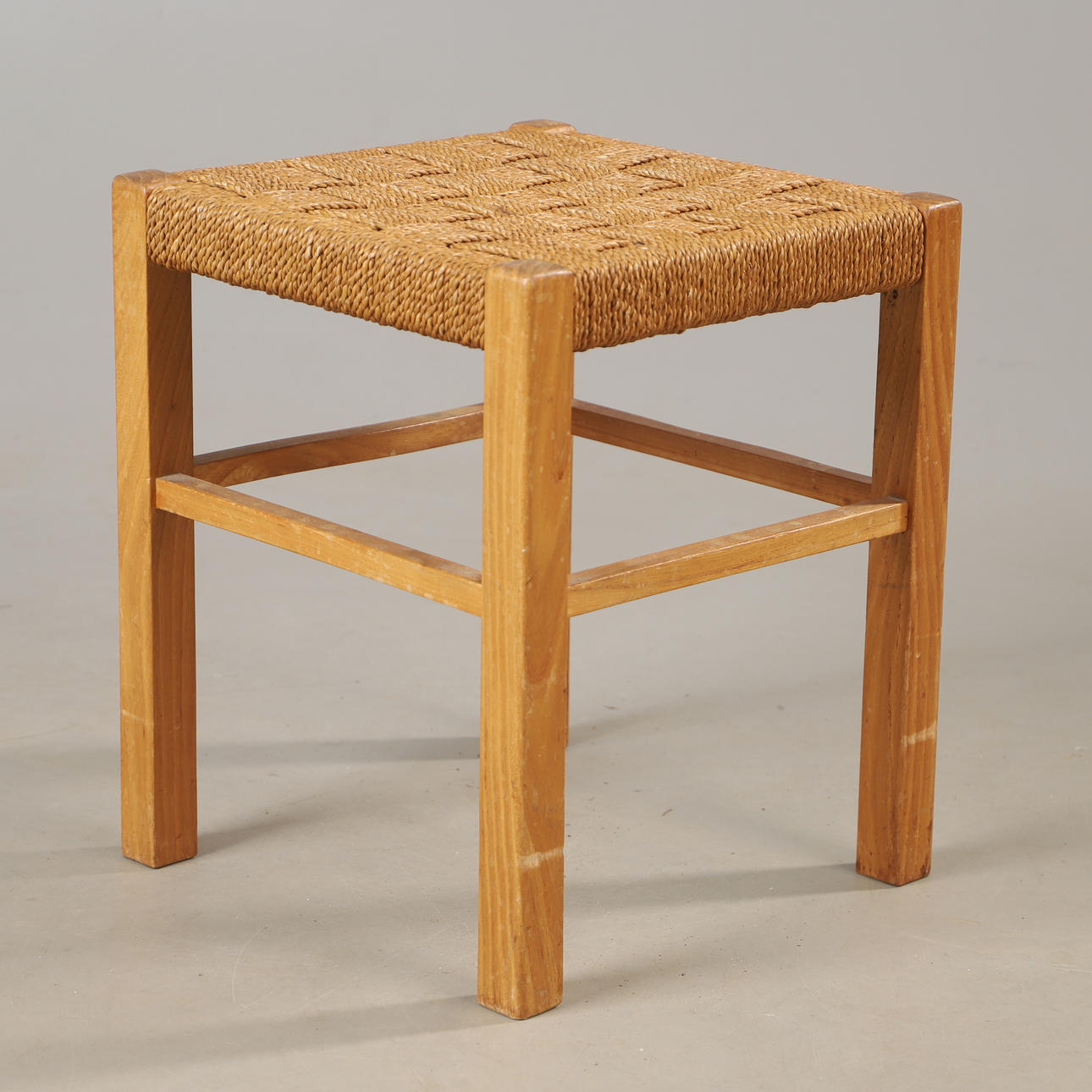 A stool, elm with string seat, mid 20th century.