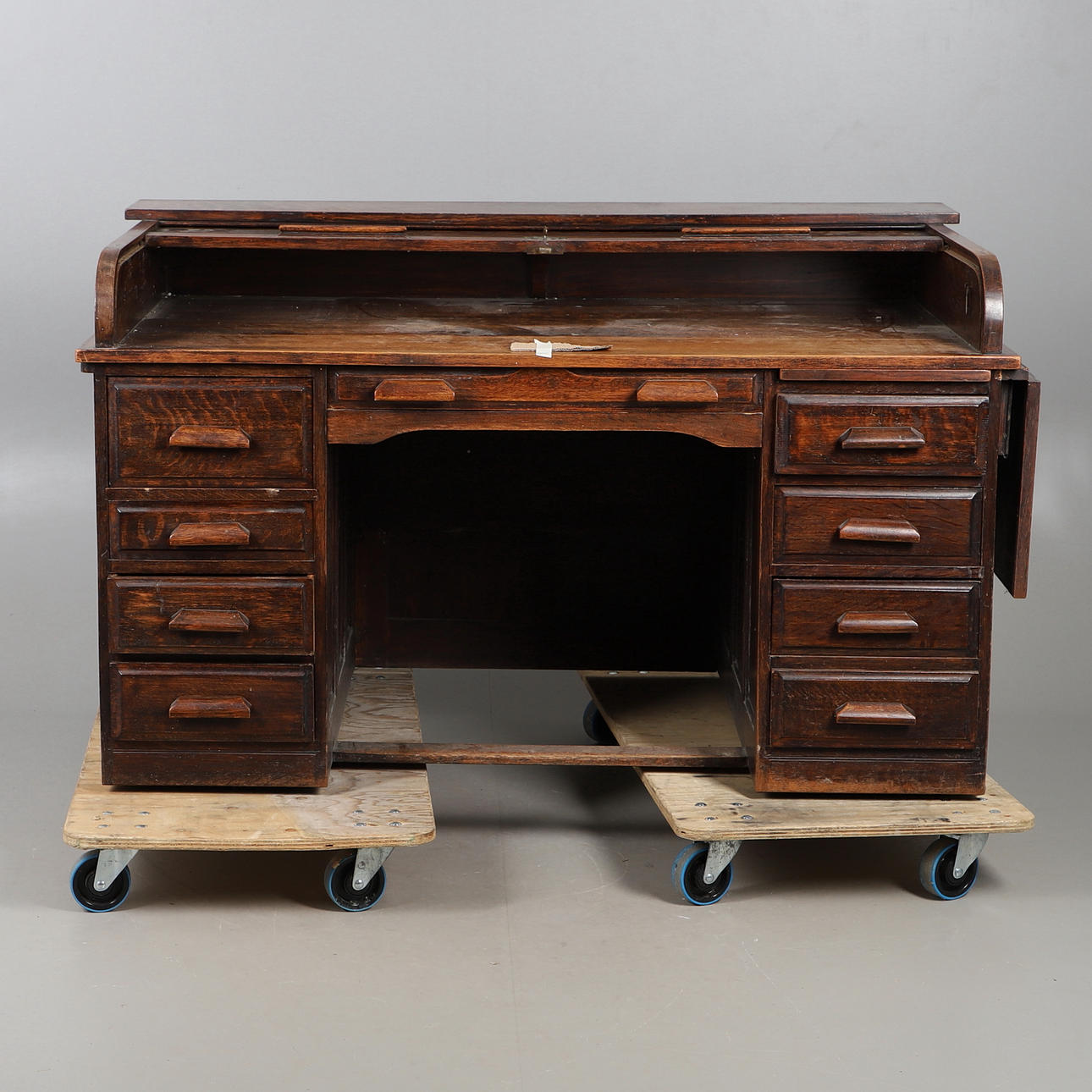 AN OAK LOW ROLL TOP DESK.