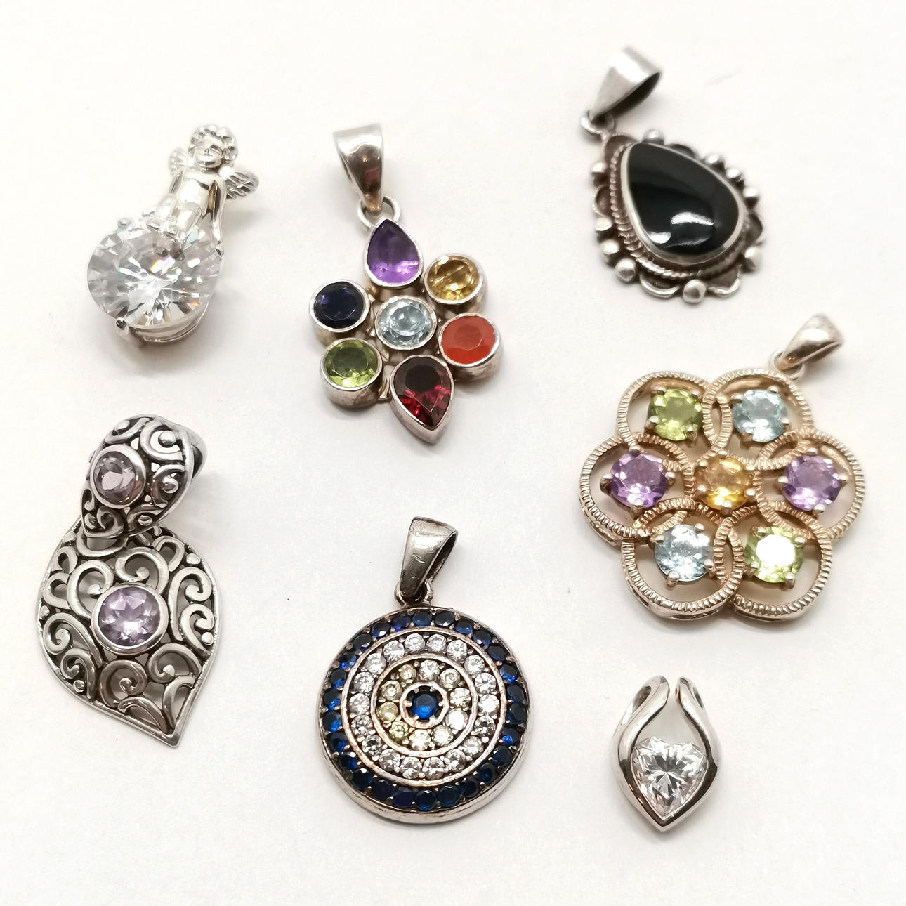 7 X SILVER PENDANTS.