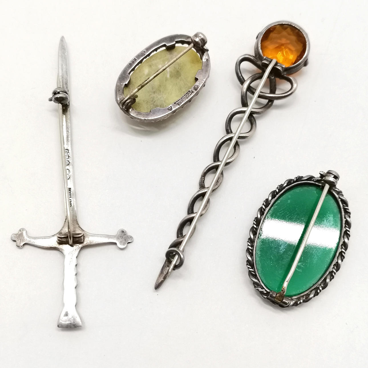 4 X SILVER BROOCHES.