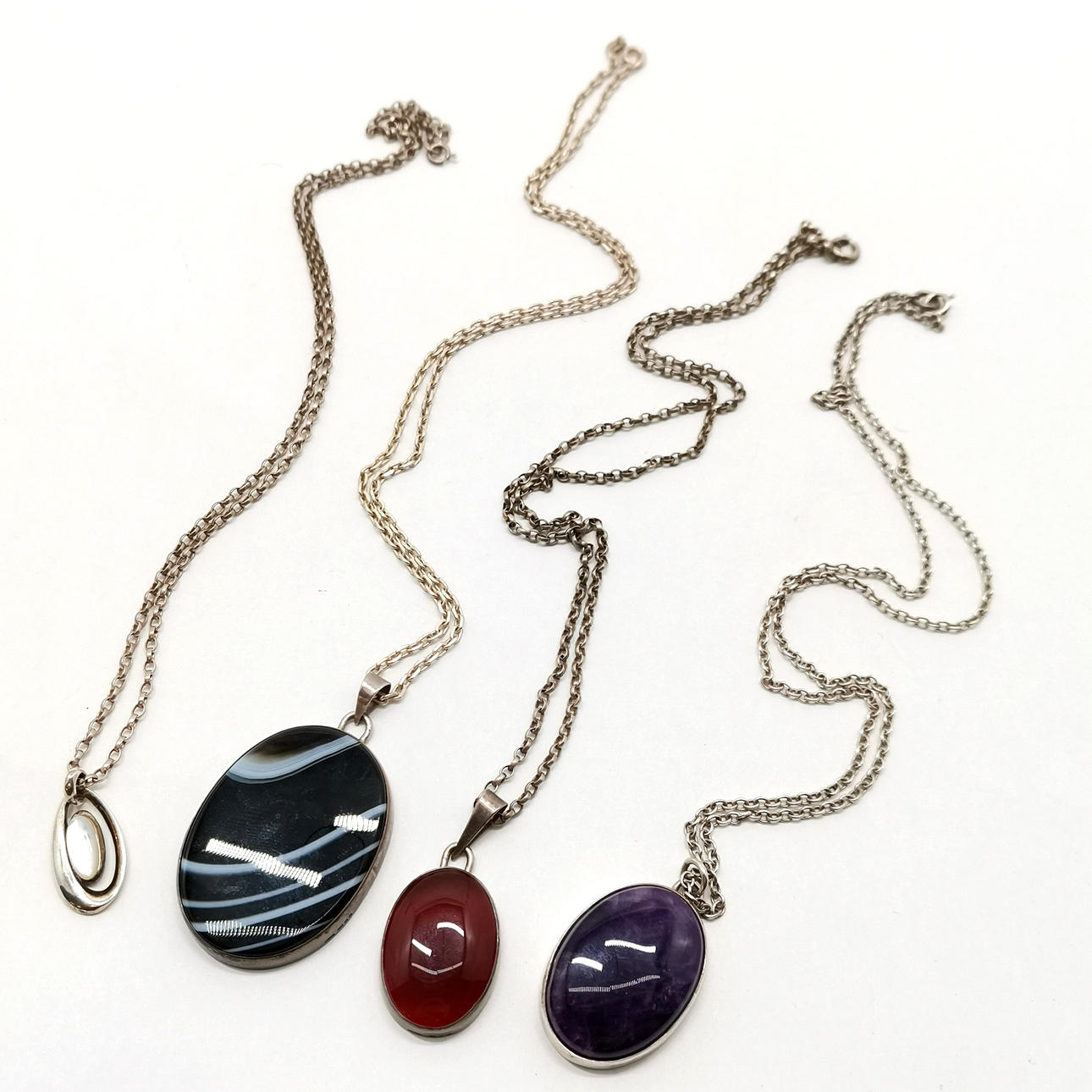 4 X SILVER STONE SET PENDANTS.