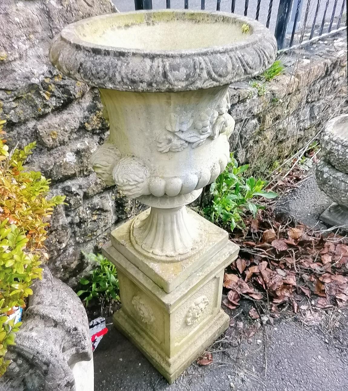 LARGE SANDFORD STONE URN ON PLINTH.