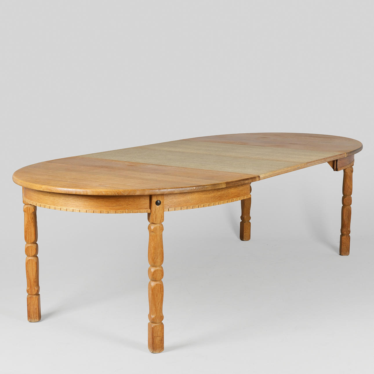 Oval oak dining table with pull-out and two additional plates, Kjærnulf stil, Danish furniture manufacturer, Denmark, circa 1960/70s, (1+2).