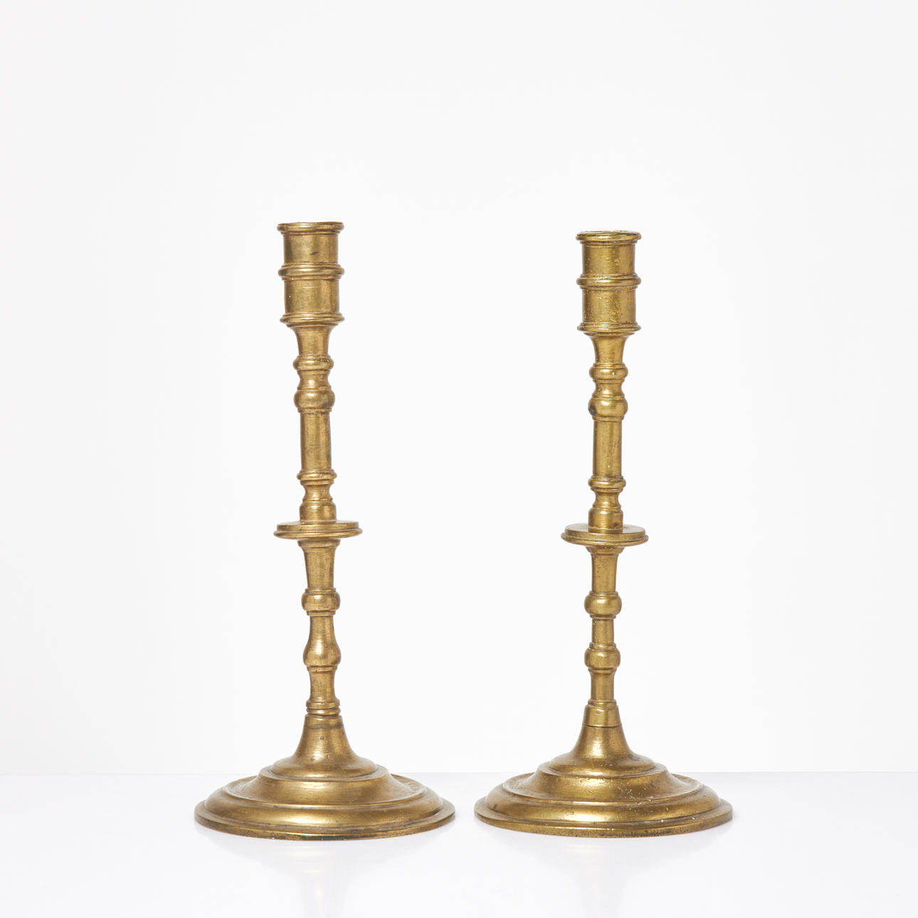 CANDLESTICKS. 1 pair, brass, 17th/18th century.