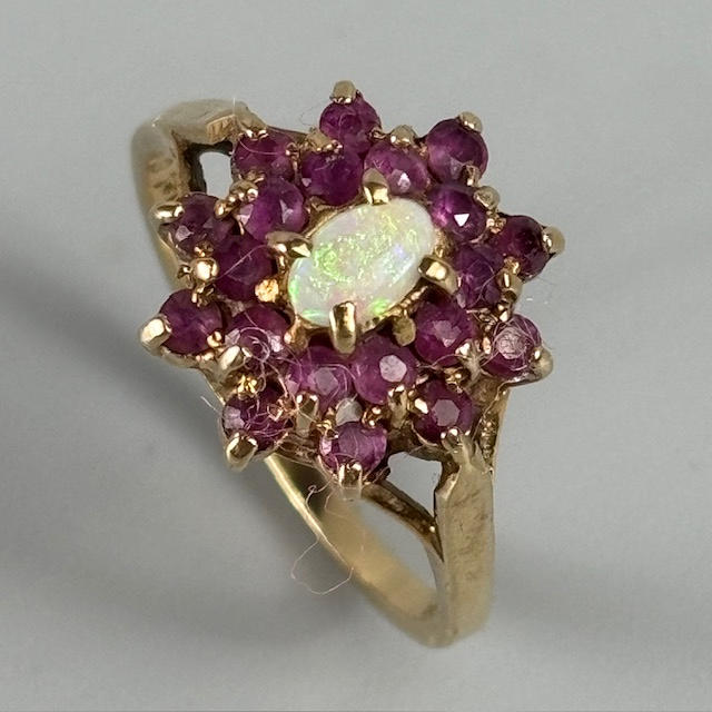 9CT GOLD RUBY AND OPAL RING.
