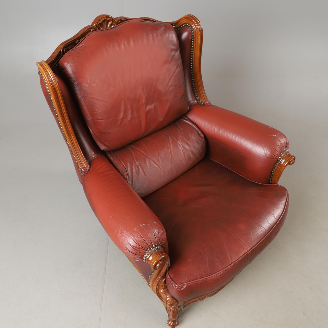 ARMCHAIRS, 1 pair, leather and beech, rococo style.
