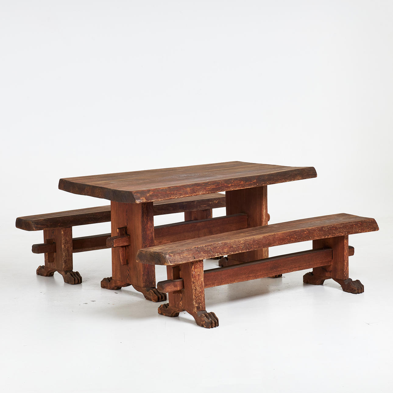 DINING GROUP, 3 dlr, mid 20th century, dining table with two benches, solid pine, hard waxed, feet in the shape of bear paws, monogram signed RS.