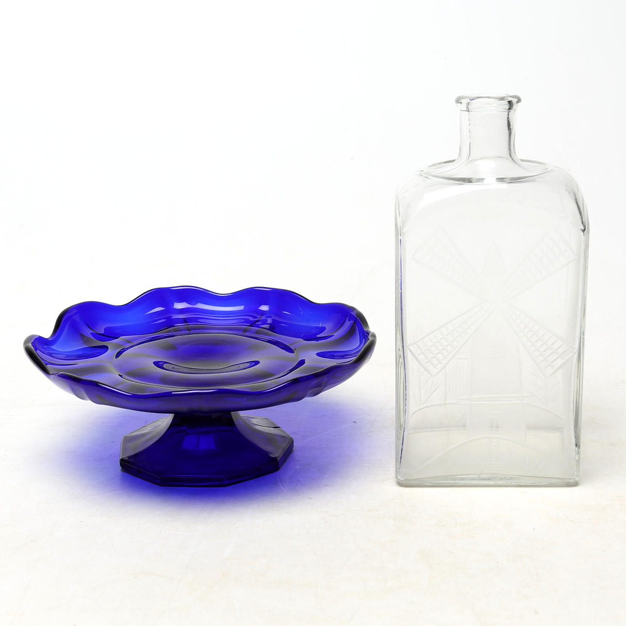 GLASS OBJECTS, 2 pcs, including one with a cut windmill motif.
