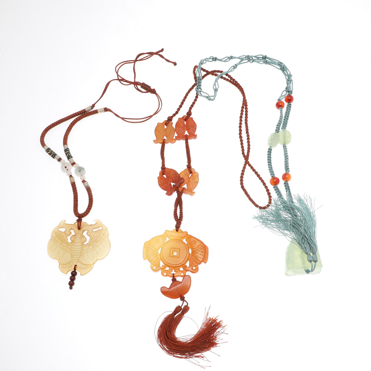 TWO CARVED JADE PENDANTS.