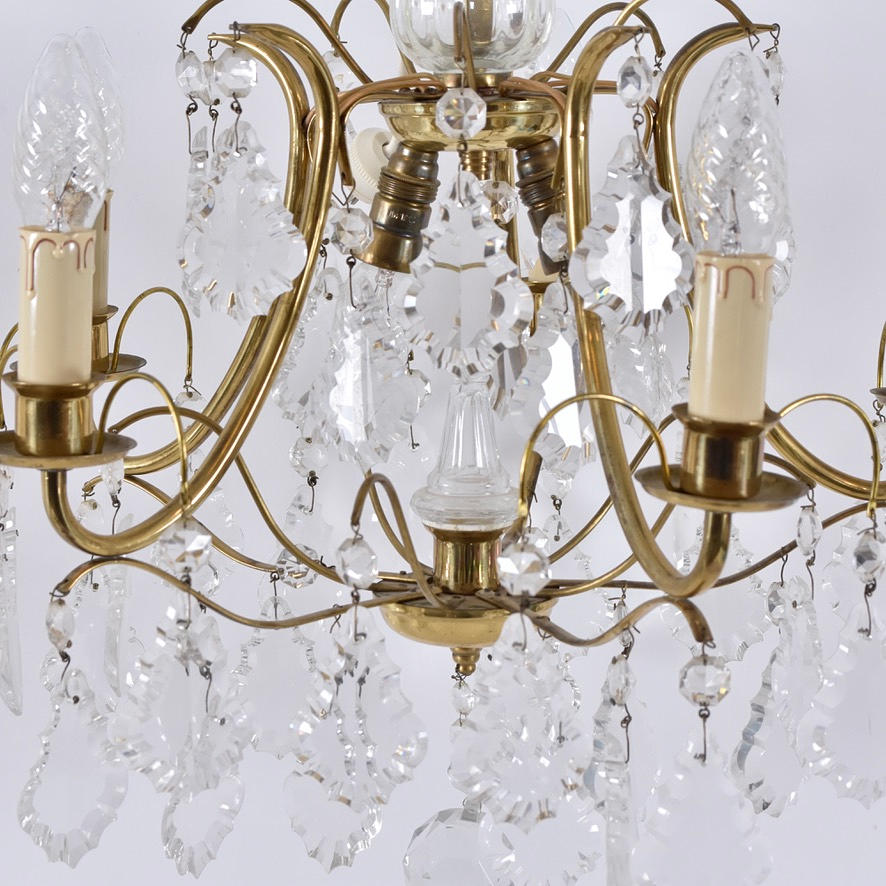 CHANDELIER; brass with leaf-shaped prisms.