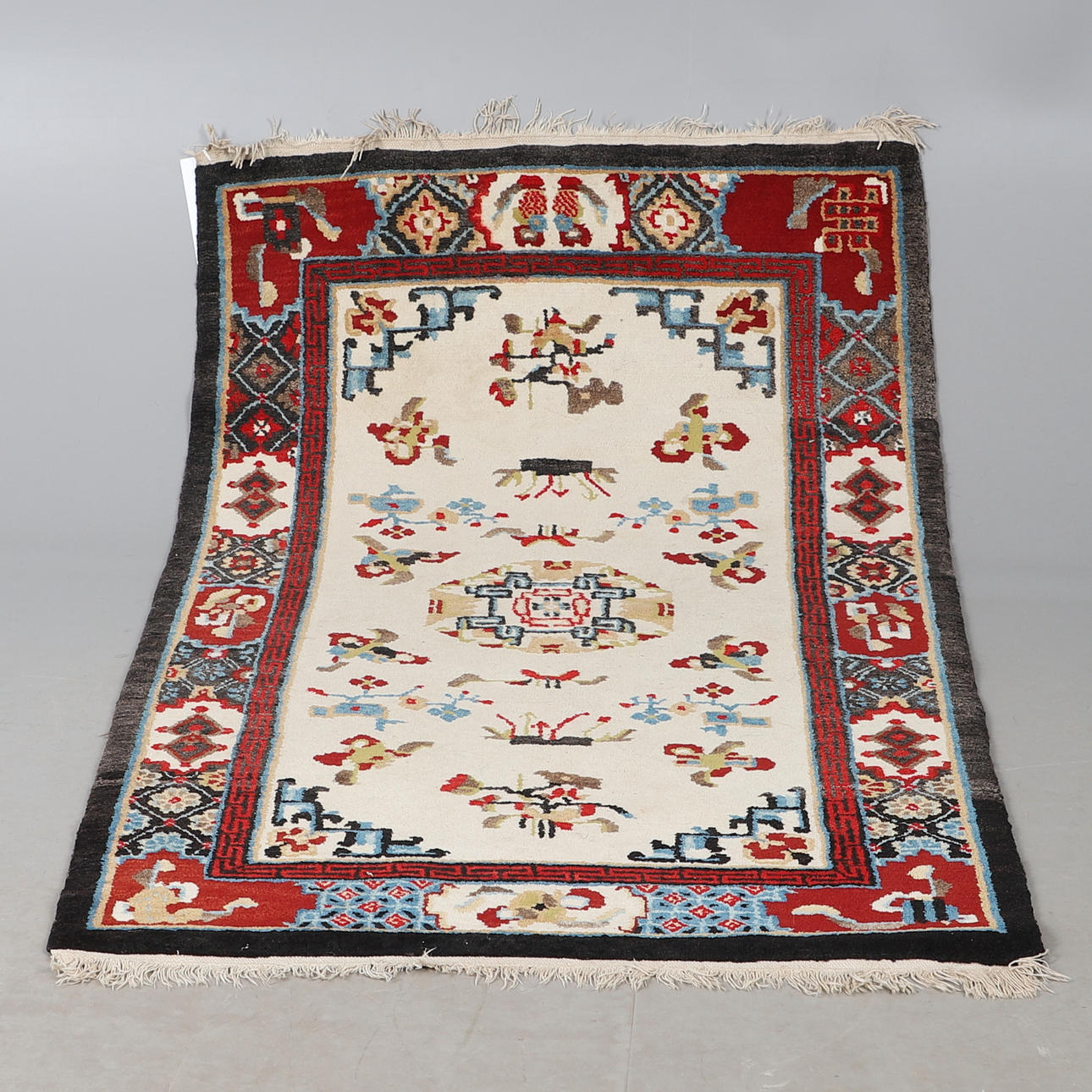 A CHINESE OR TIBETAN RUG.