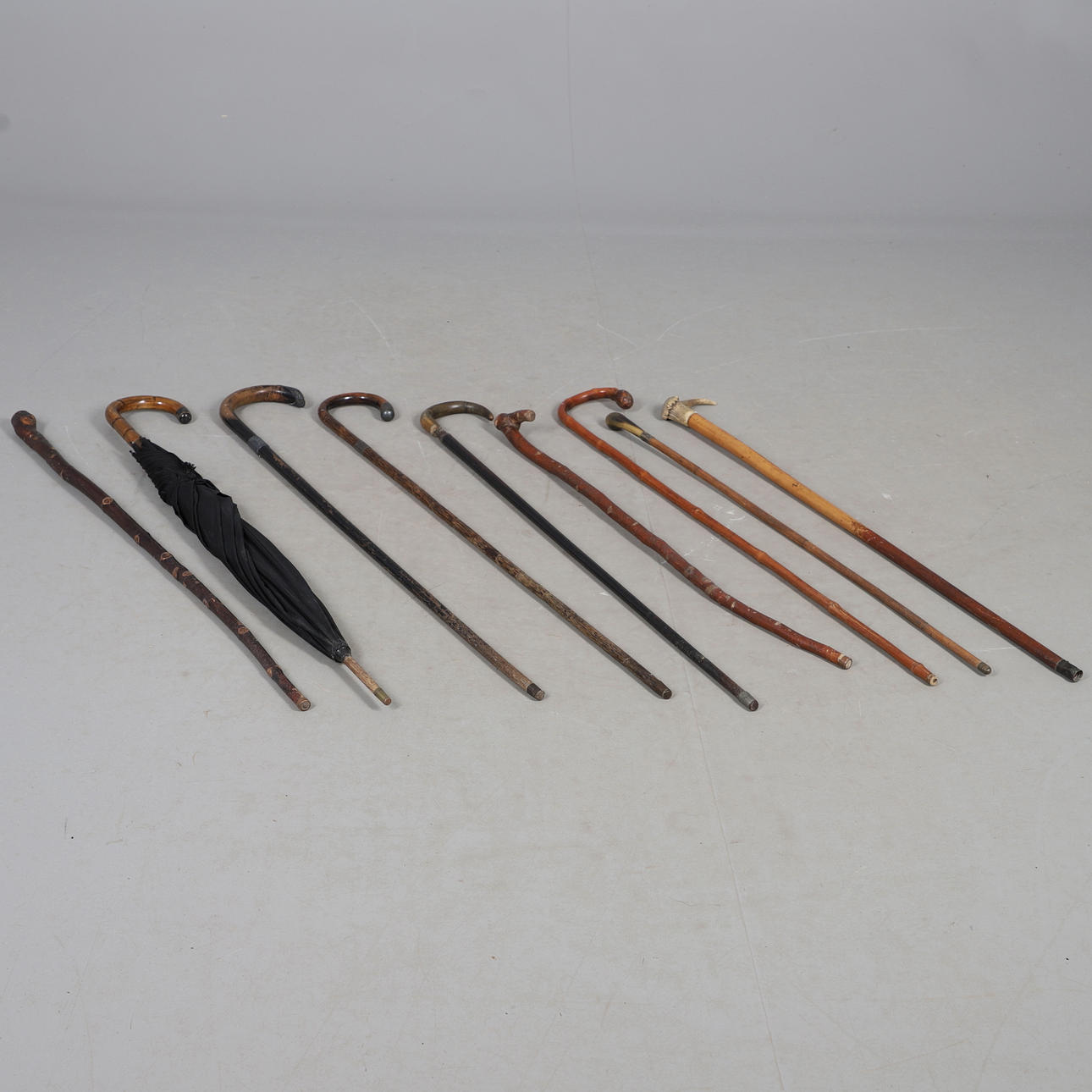 VARIOUS ANTIQUE WALKING STICKS & UMBRELLA.