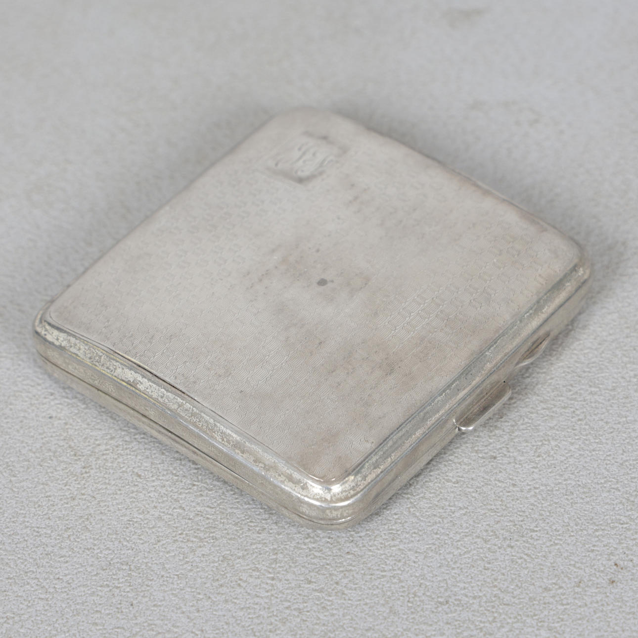 A GEORGE V SILVER CIGARETTE CASE.