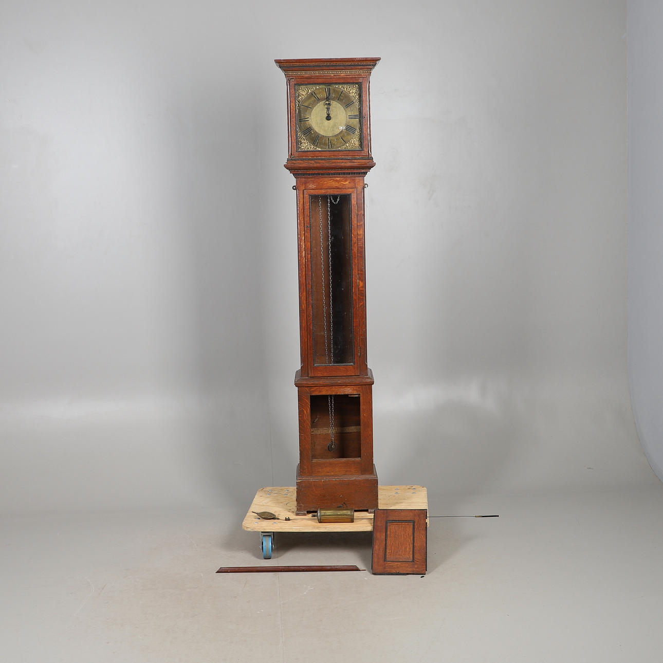 AN OAK LONGCASE CLOCK.