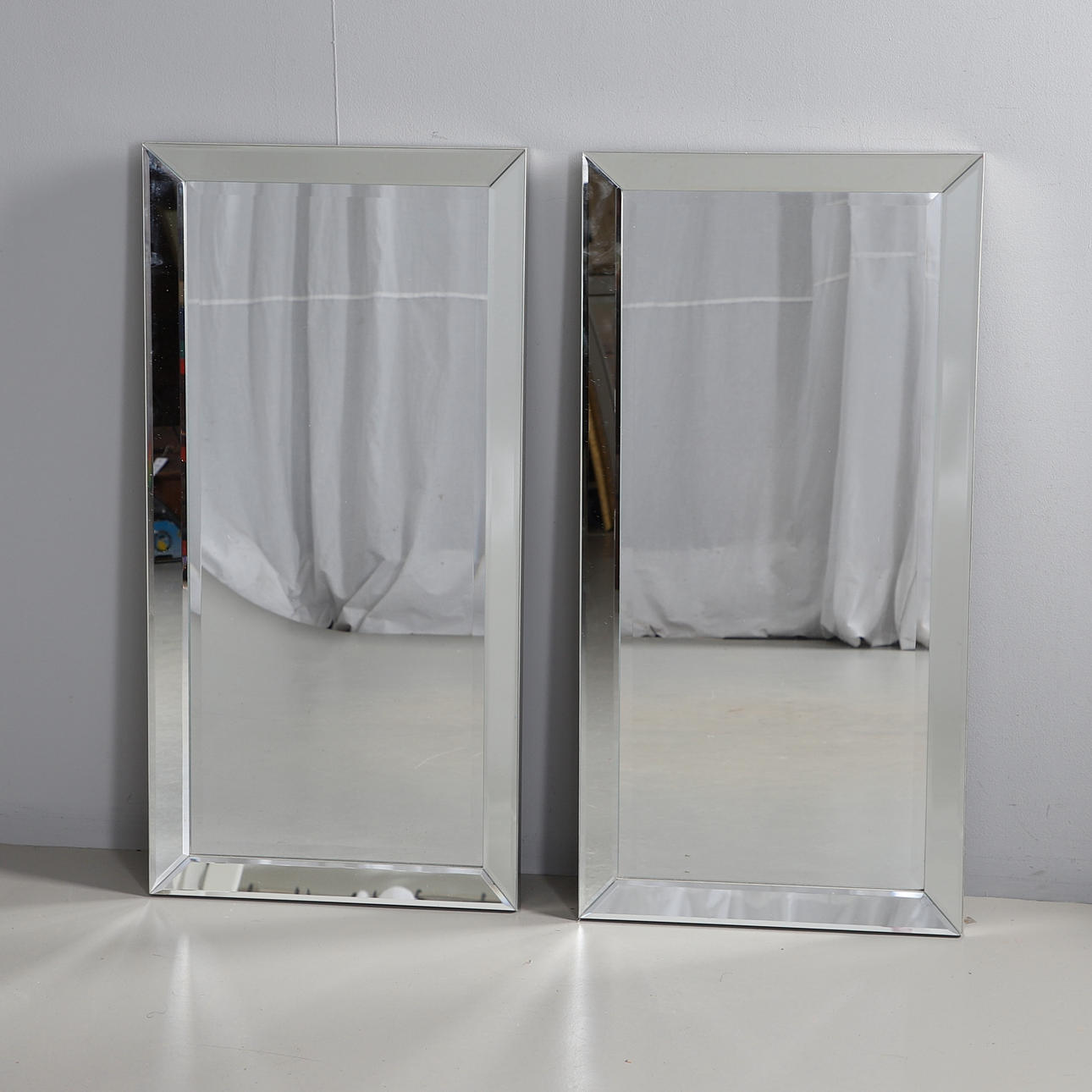 TWO MODERN SILVER FRAMED MIRRORS.