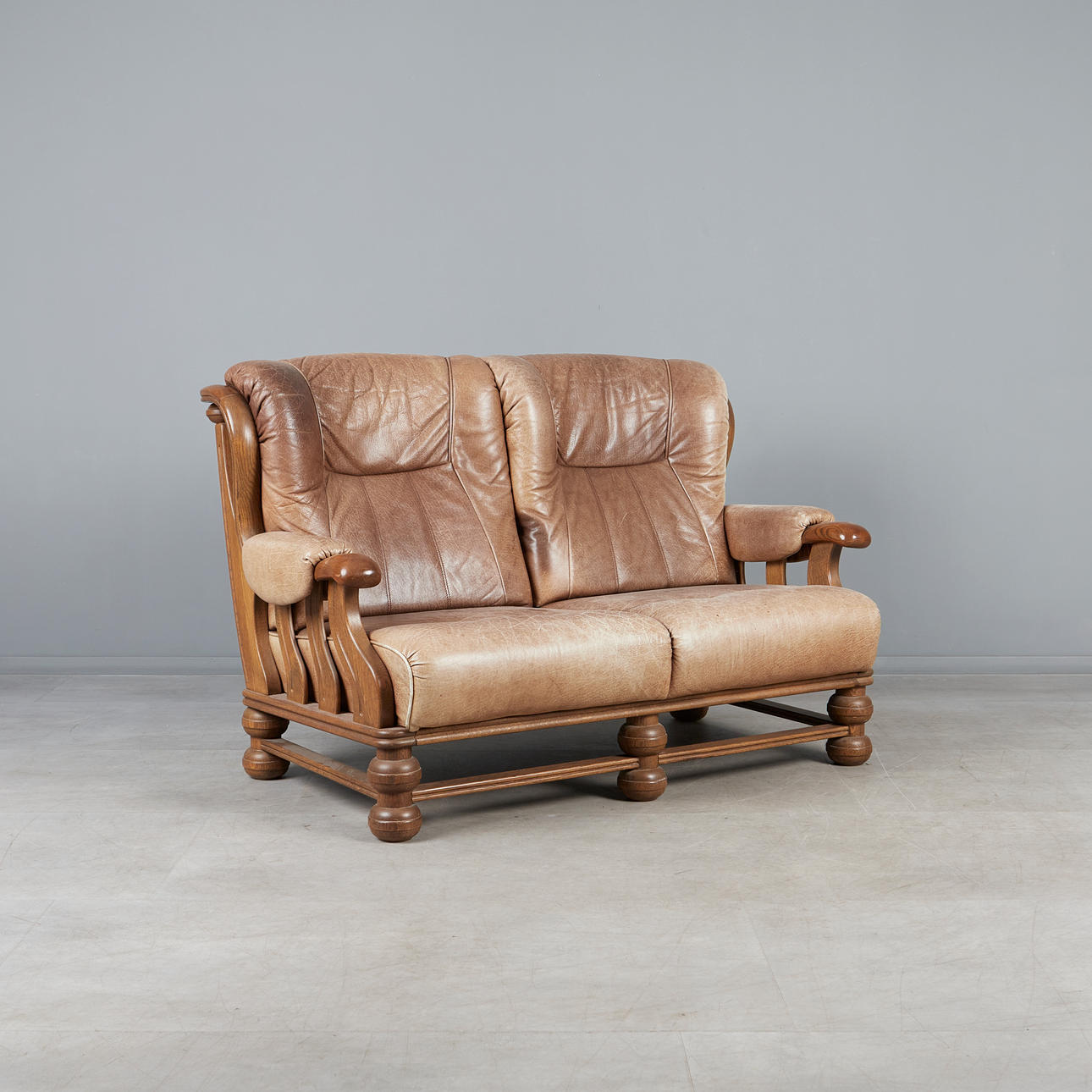 BRUTALIST SOFA / Two-seater, oak, leather, 1970s.