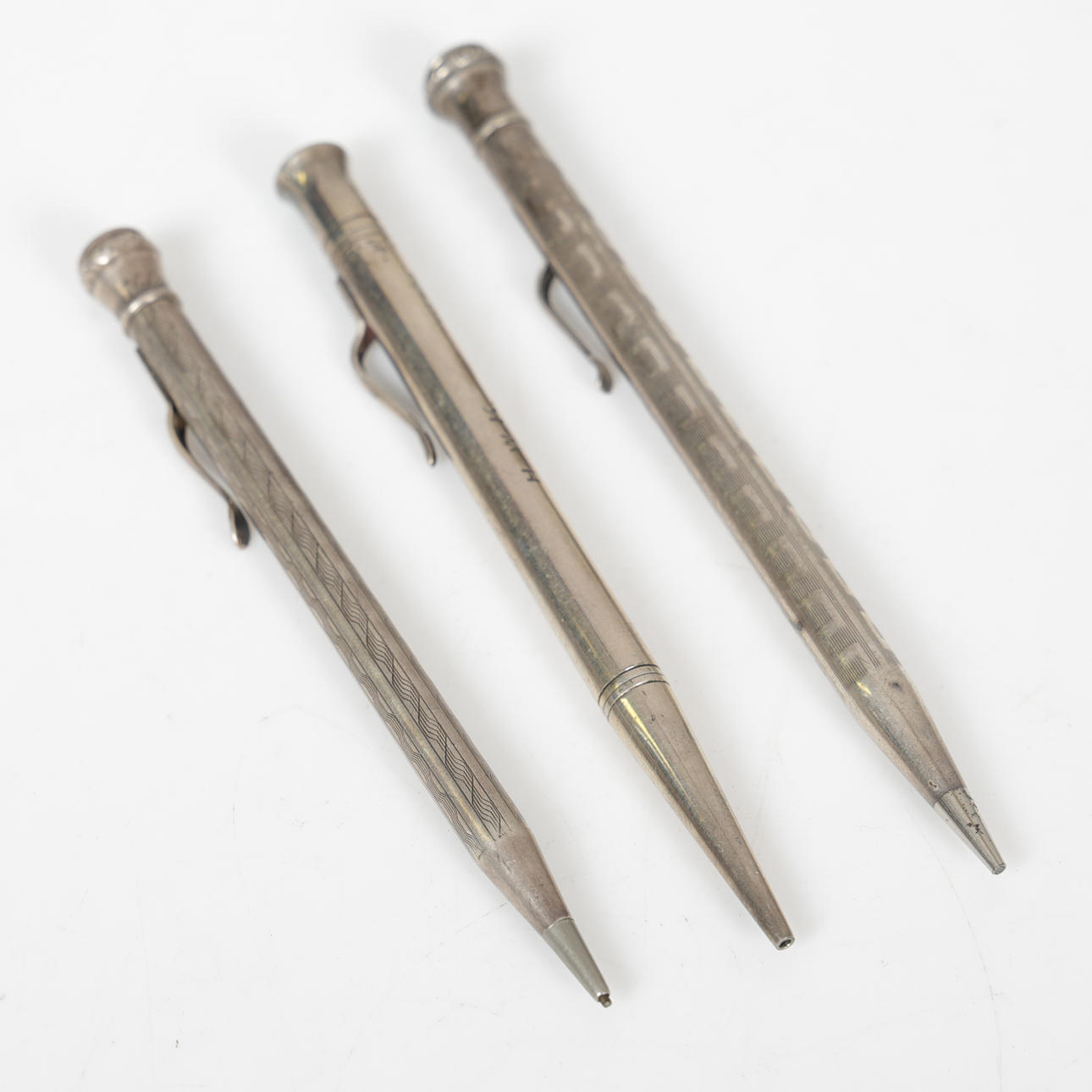 THREE SILVER PROPELLING PENCILS (3).