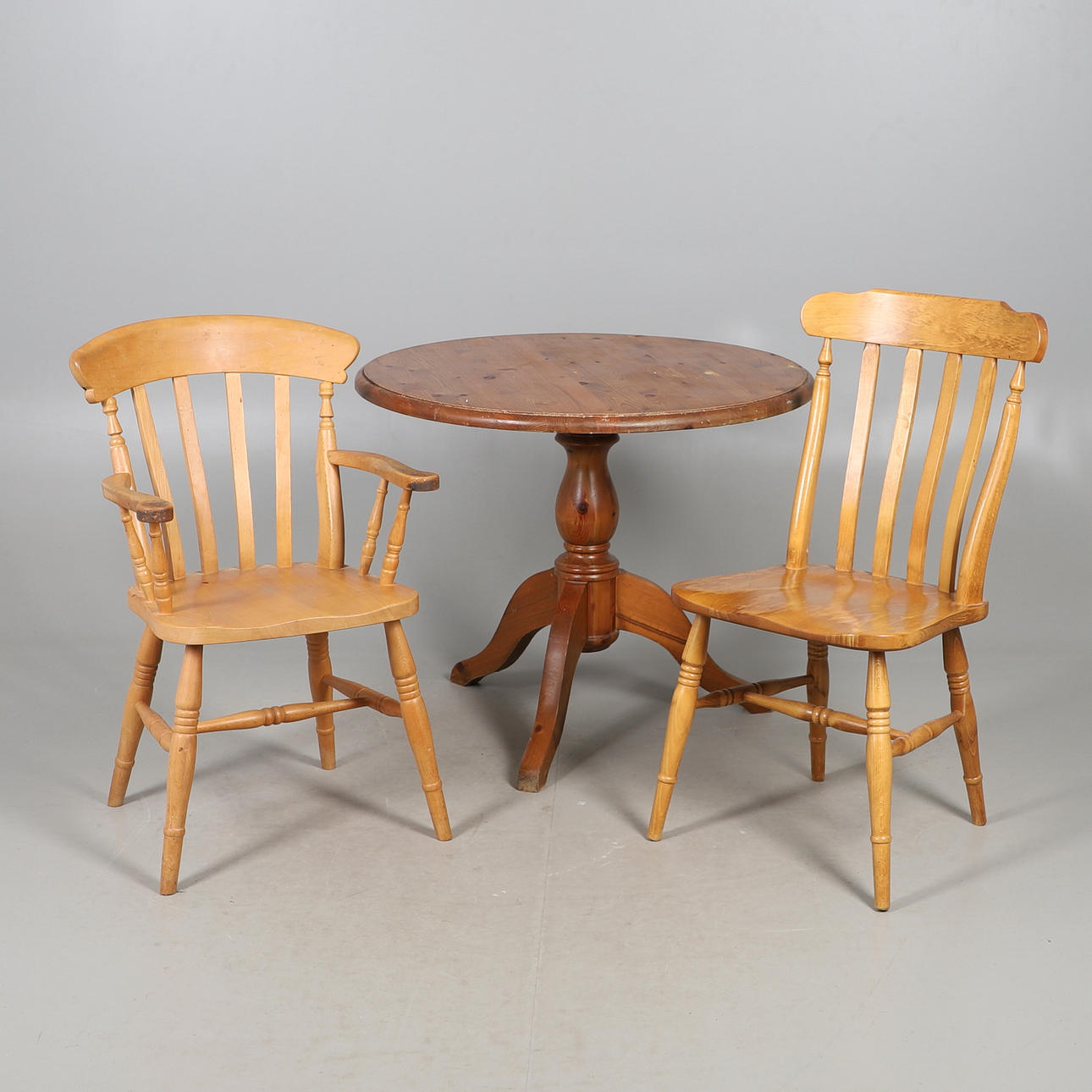 A MODERN PINE KITCHEN TABLE AND TWO CHAIRS.