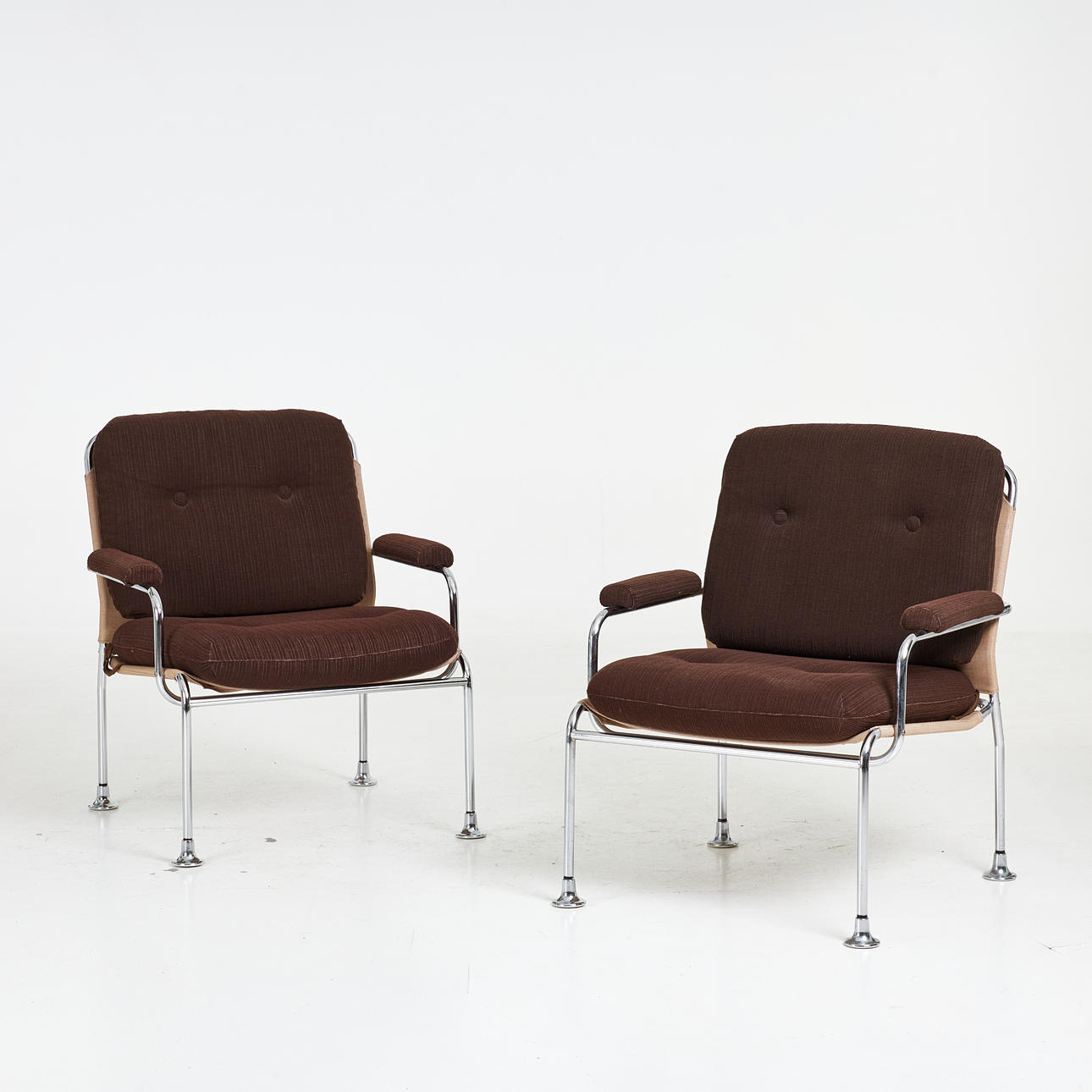 ARMCHAIRS, 1 pair, brown upholstery, chrome frames, loose cushions.