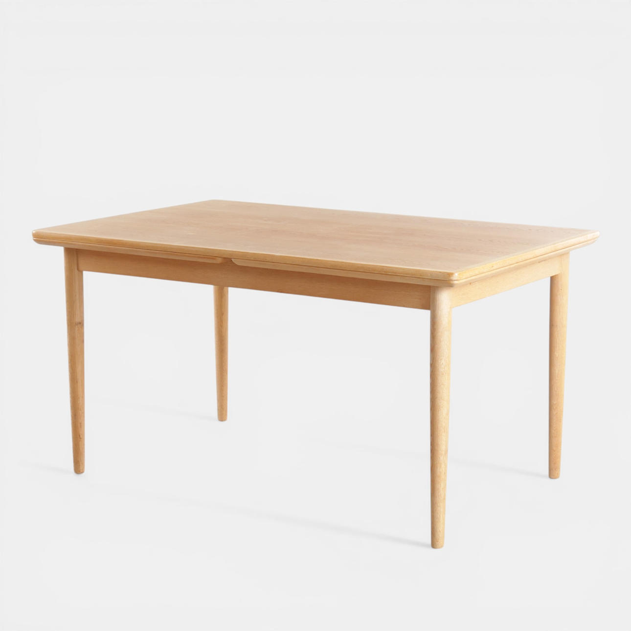 Rectangular dining table in oak, top with Dutch pull-out leaves, round tapered legs. Denmark, 1960s.