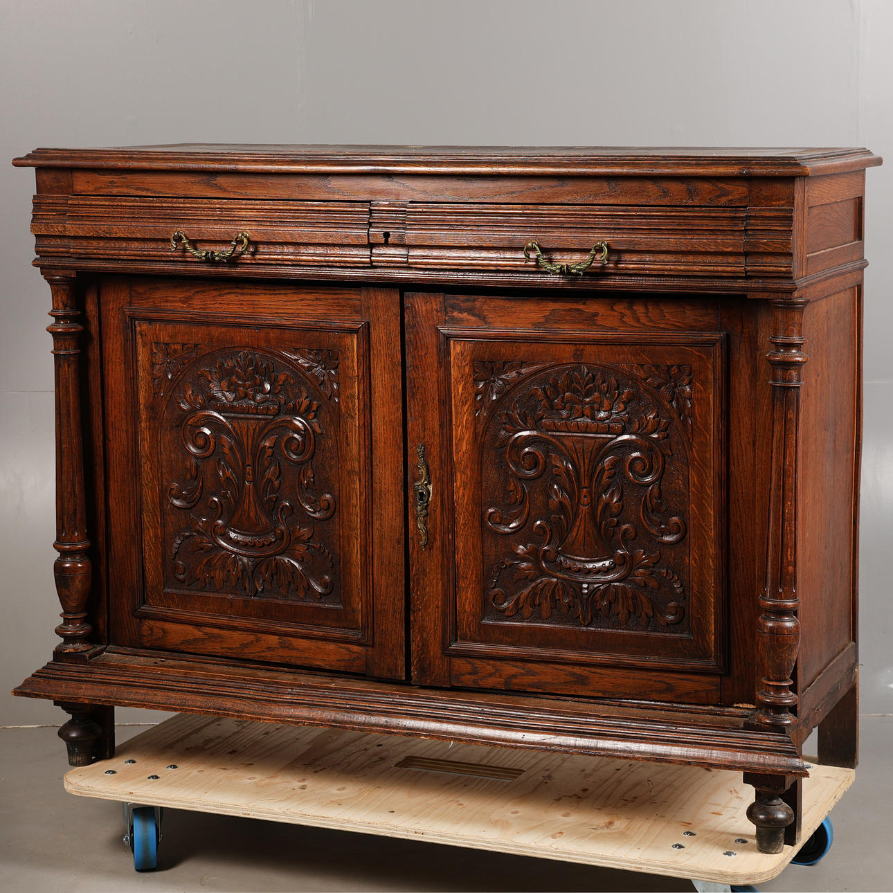 A CONTINENTAL OAK CUPBOARD.