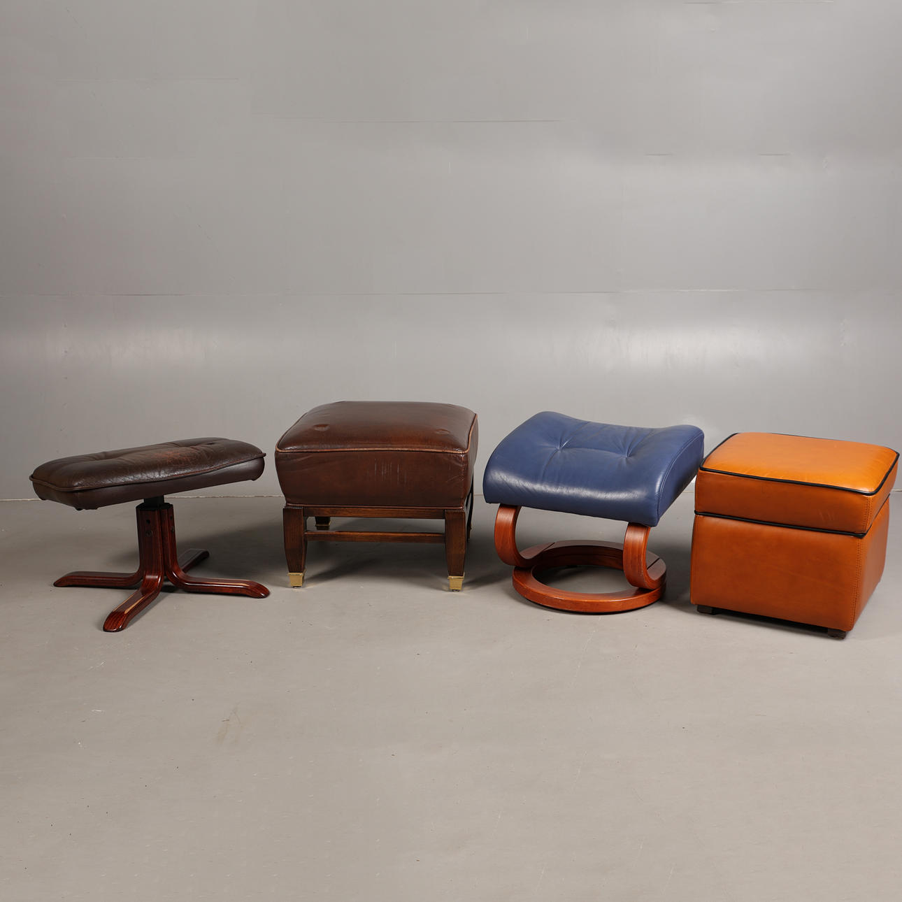 FOUR LEATHER AND LEATHER-STYLE FOOT STOOLS (4).