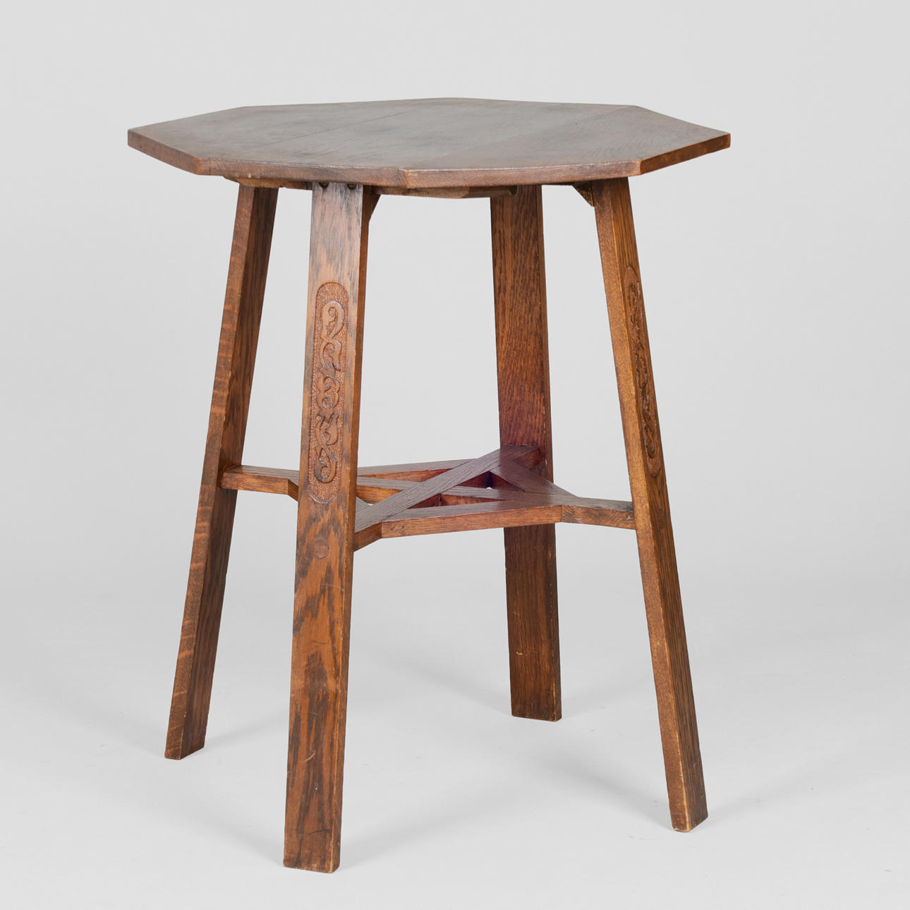 Octagonal table in stained solid oak, first half of the 20th century.
