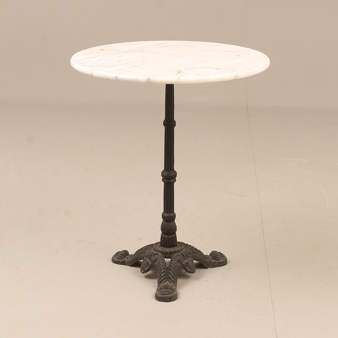 GARDEN TABLE, cast iron with stone top.