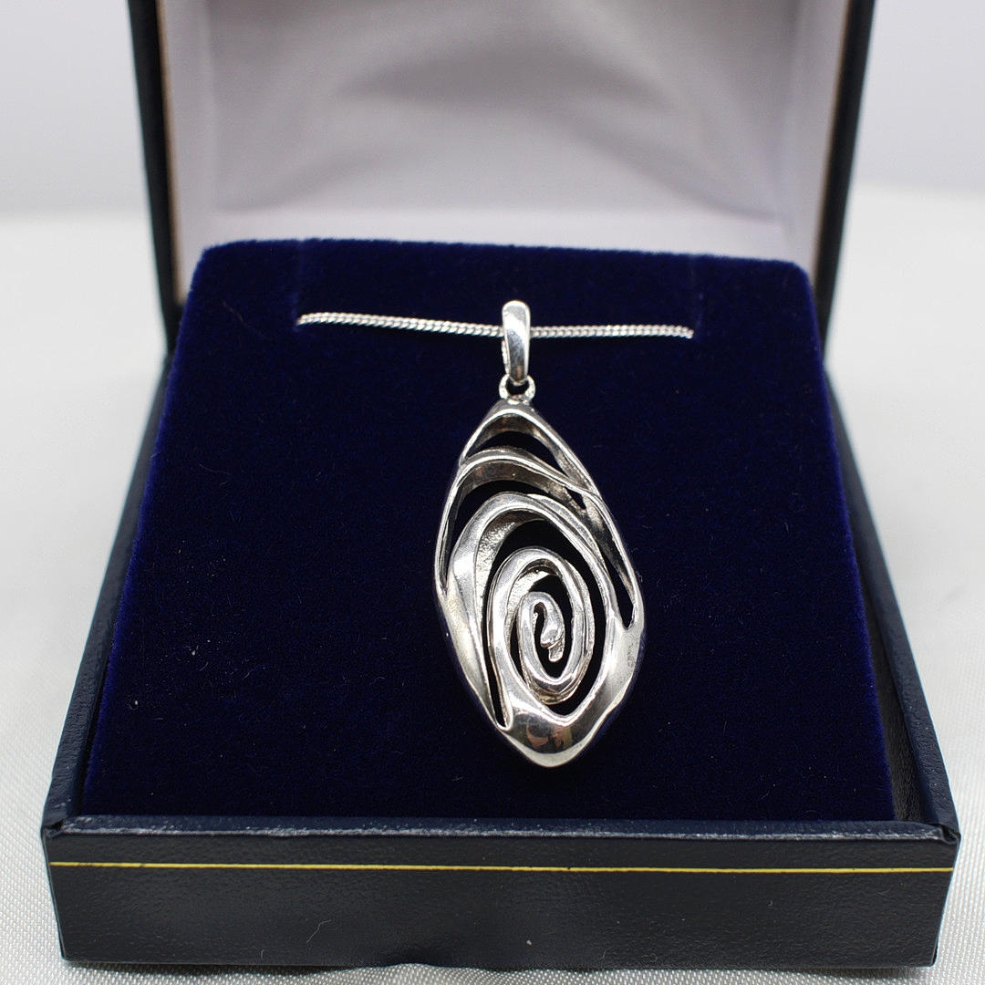 SILVER PENDANT ON A SILVER CHAIN.