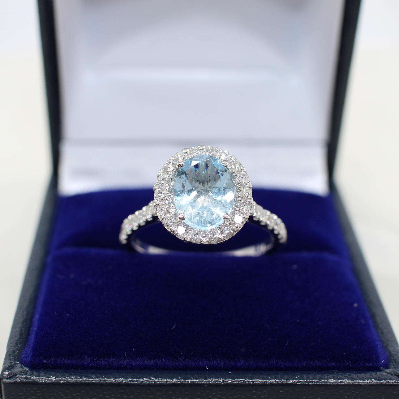 AQUAMARINE & DIAMOND HALO RING.