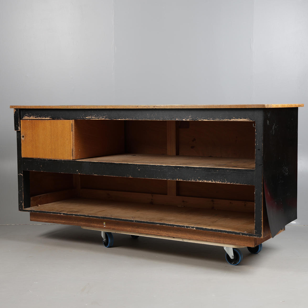 A LIGHT OAK-TOPPED SHOP COUNTER.