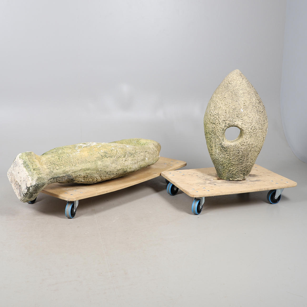 TWO RECONSTITUTED STONE STATUES.