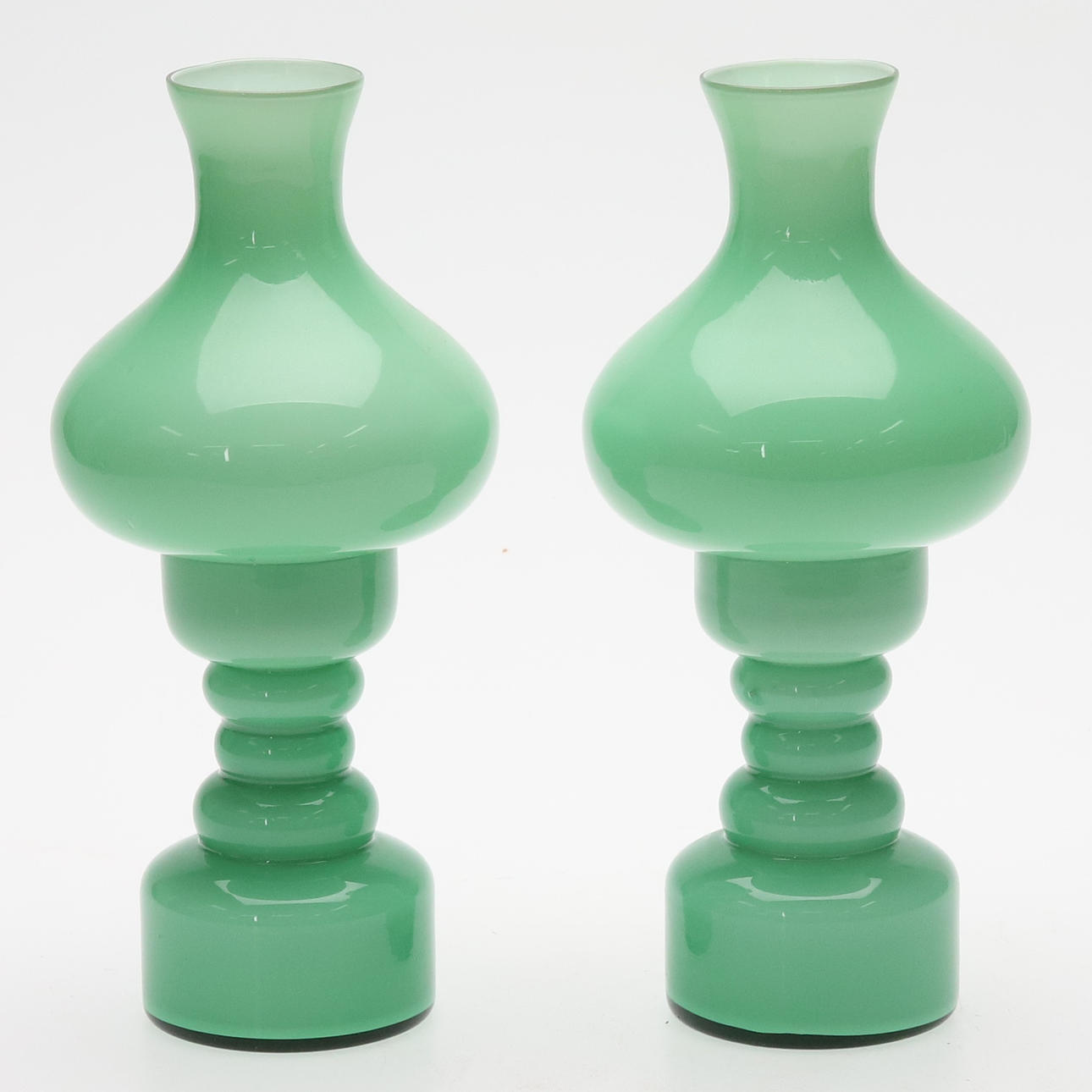 CANDLESTICKS/TABLE LAMPS, green glass, a pair.