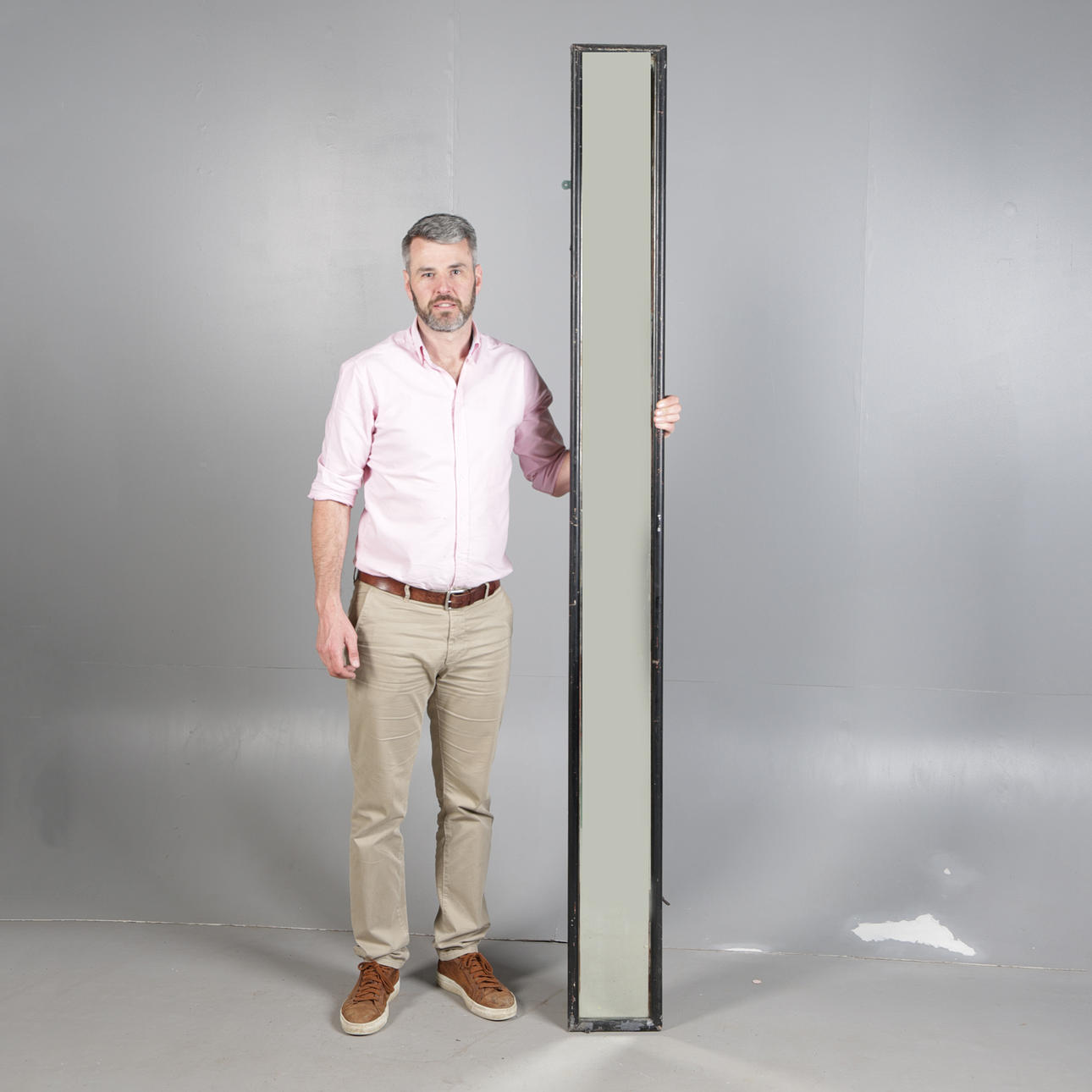 A TALL AND NARROW TAILOR'S MIRROR.