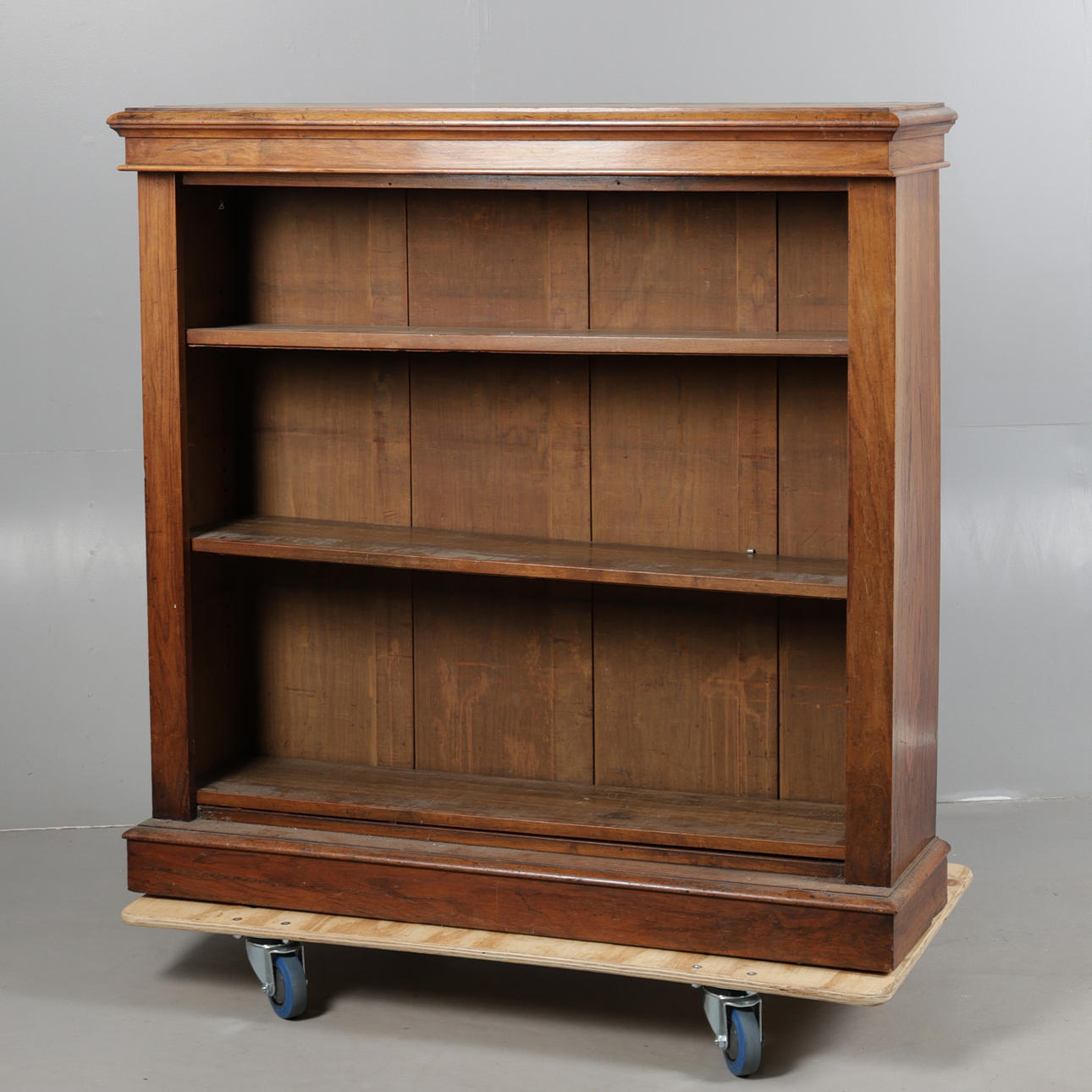 A VICTORIAN WALNUT OPEN BOOKCASE.