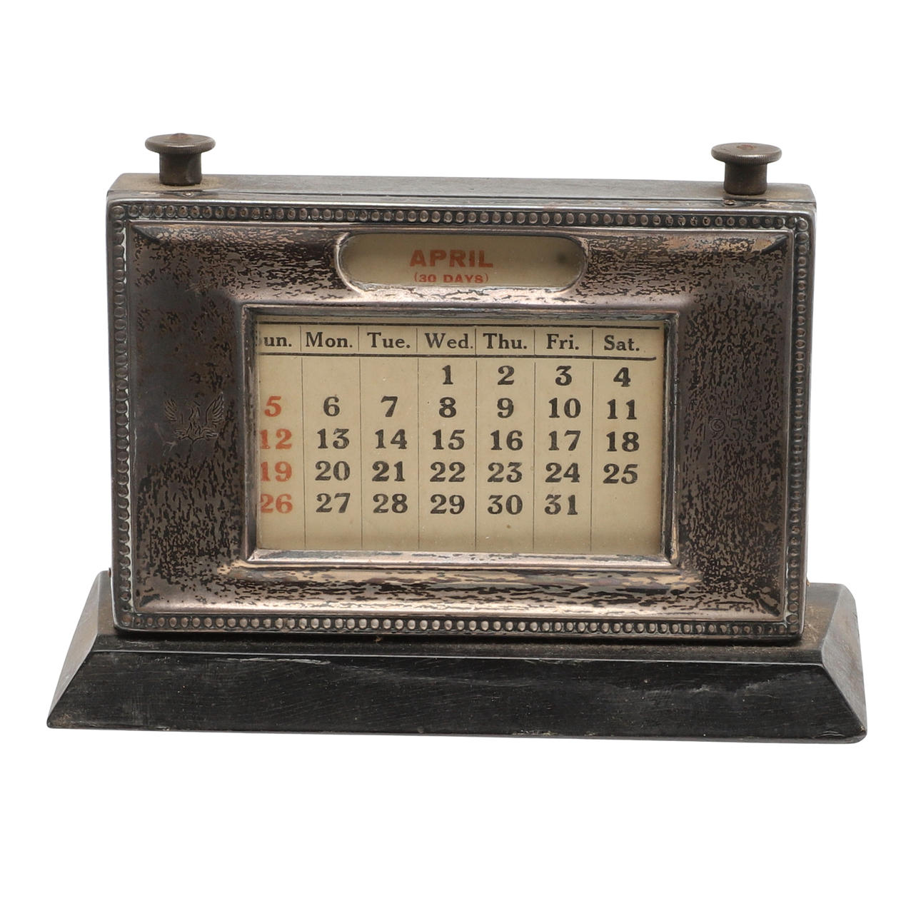 A SILVER FRONTED PERPETUAL DESK CALENDAR.