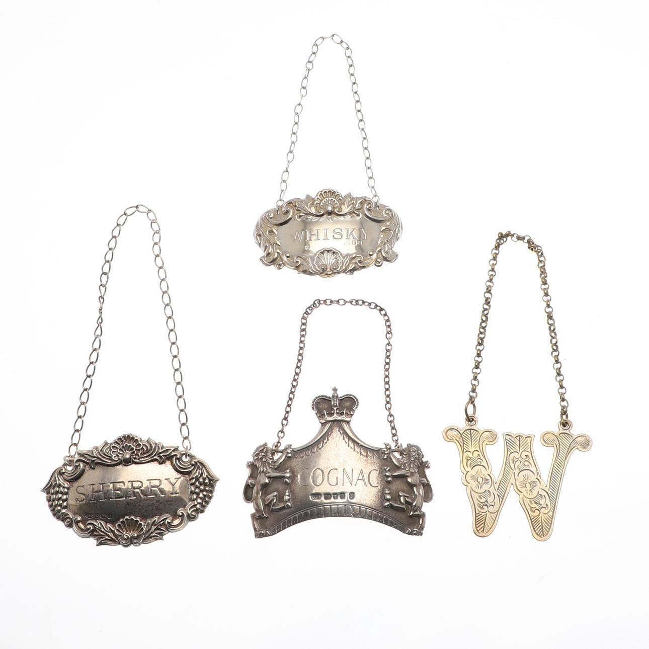 THREE SILVER DECANTER LABELS AND ANOTHER SILVER PLATED.