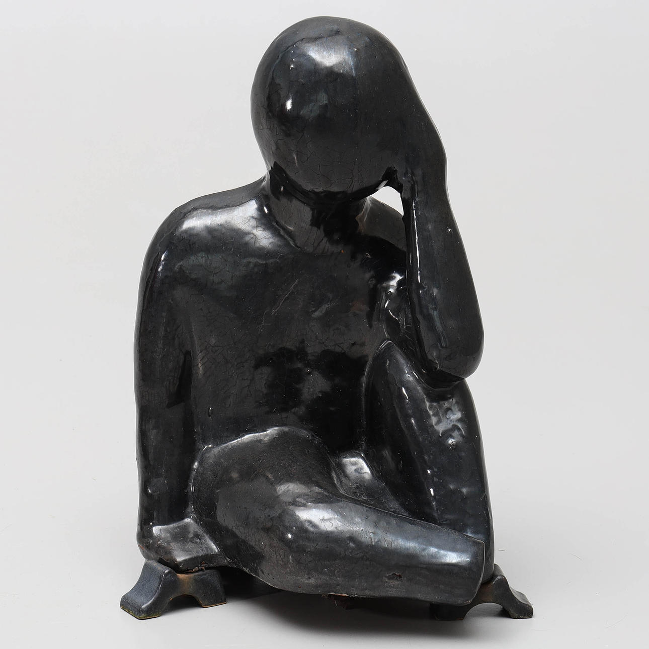 SCULPTURE, glazed ceramic, depicting a seated man.