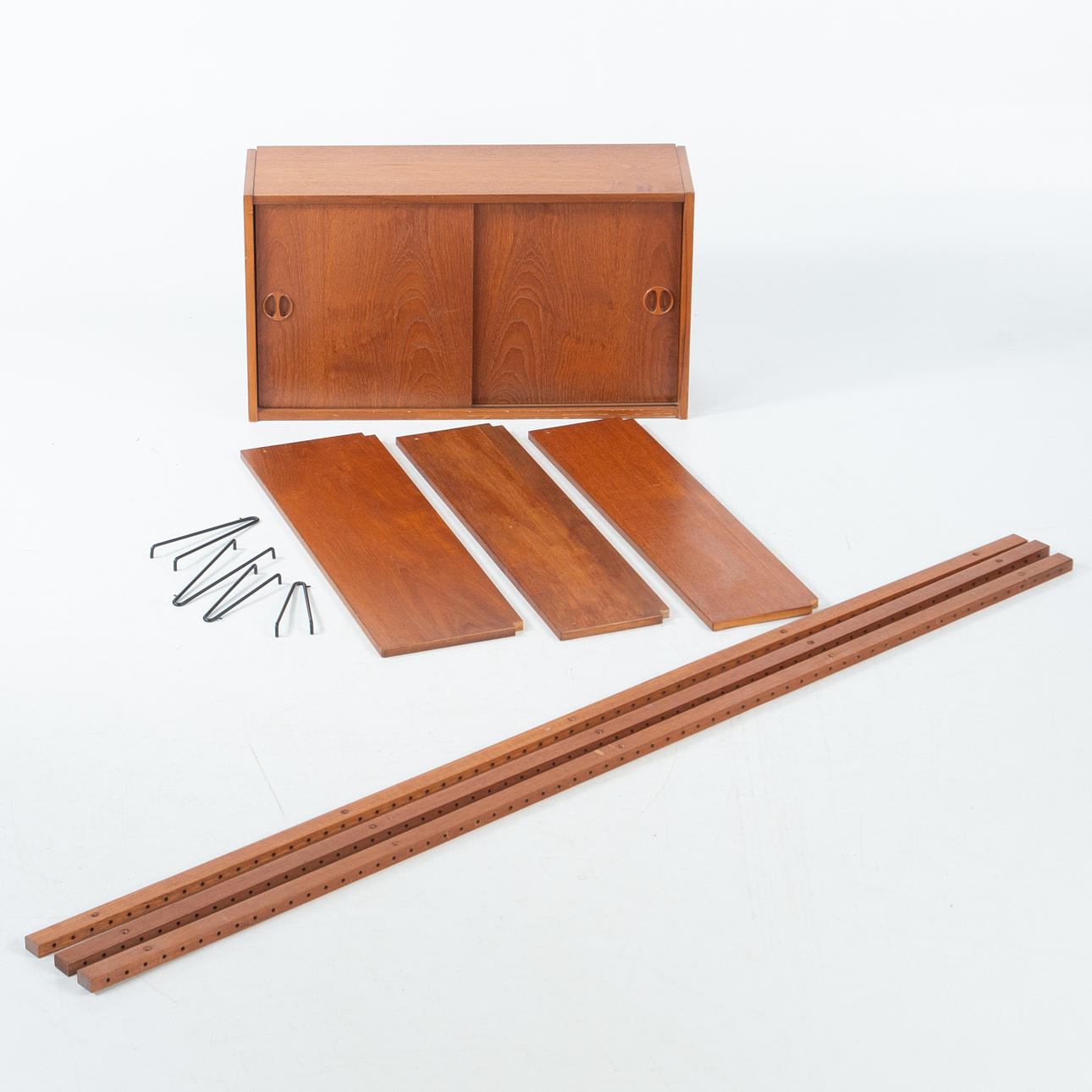 SVEN ANDERSEN. freestanding shelving system in two sections, teak, Norway, 1960s.