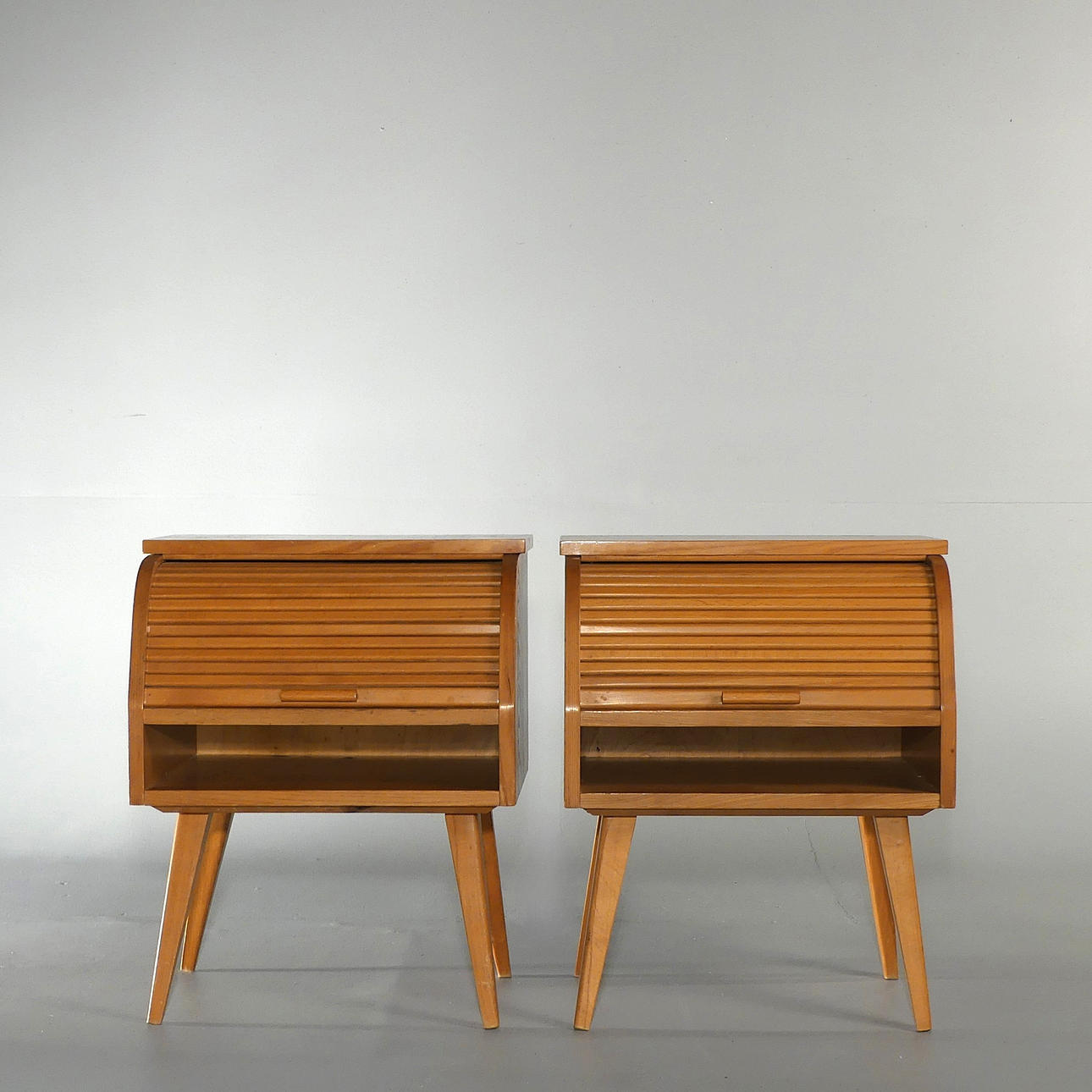 BEDSIDE TABLES WITH TAMBOUR DOOR, a pair.